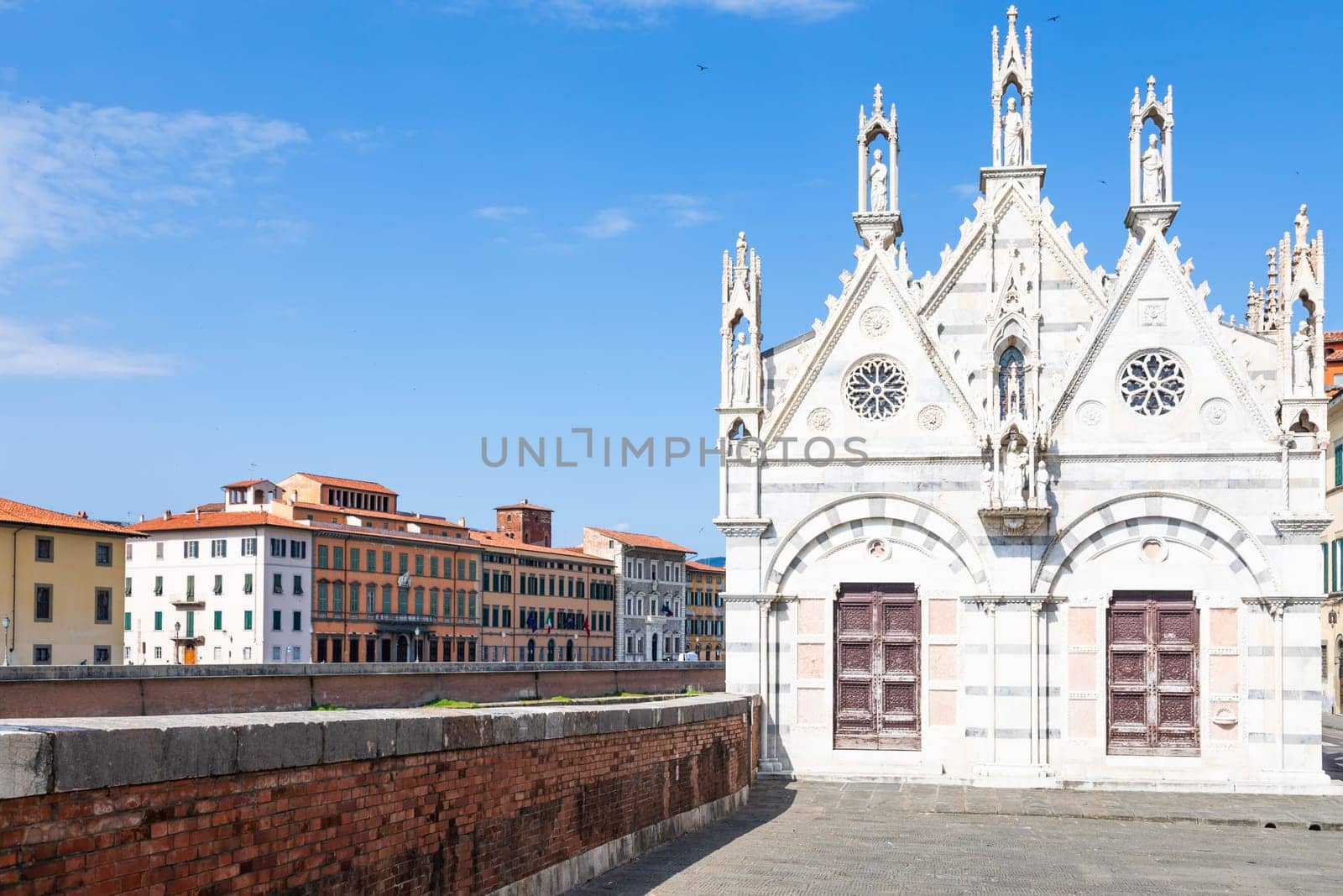 Pisa, Italy - 29 June 2023: colourful buildings on Arno river. Urban skyline, travel destination.