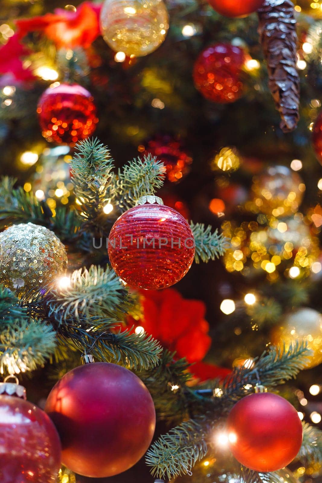 Close up of balls on christmas tree. Bokeh garlands in the background. New Year concept.