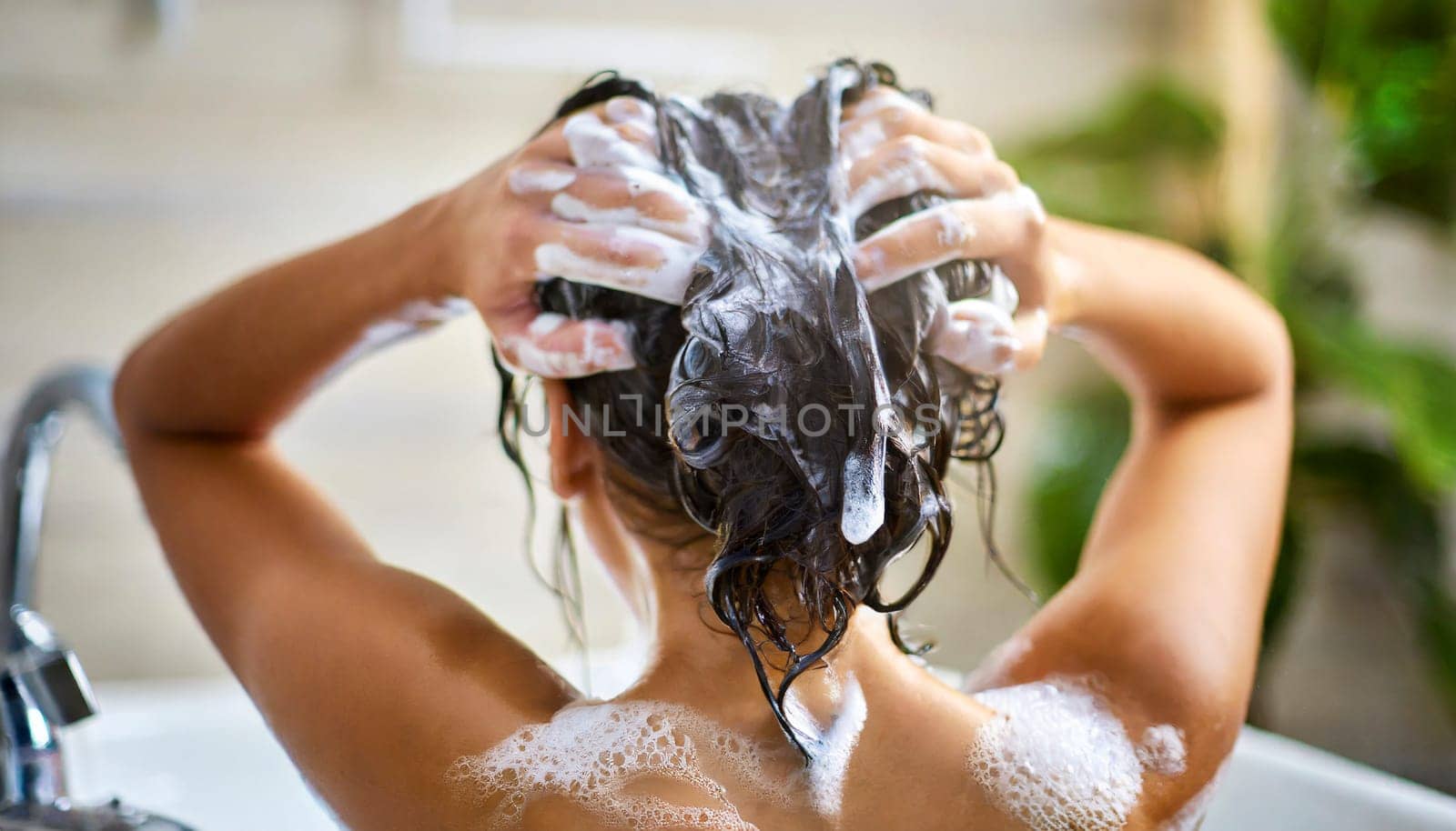 Woman washing his hair in the shower, close-up, rear view. AI generated