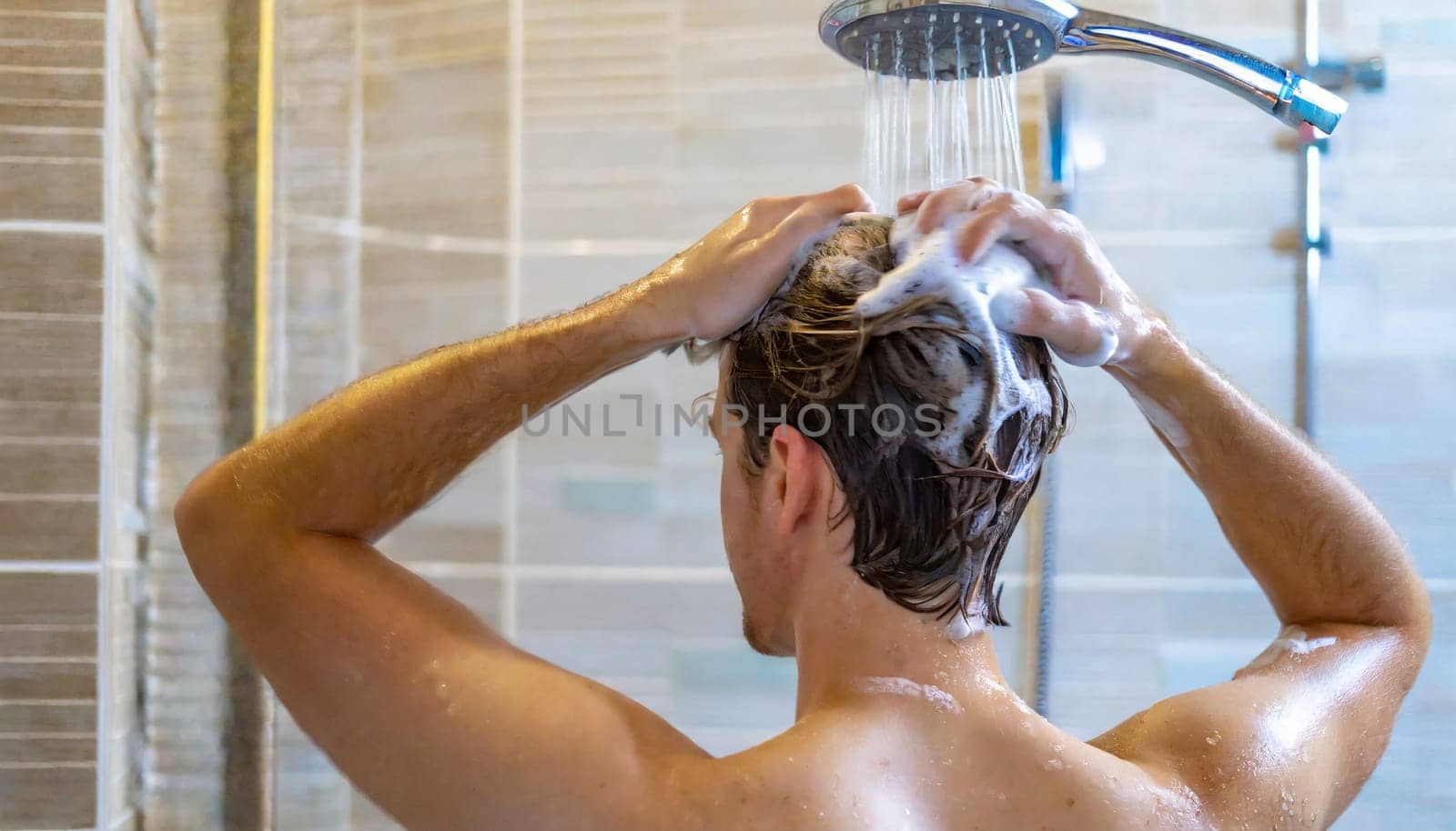 Man washing his hair in the shower, close-up, rear view. AI generated