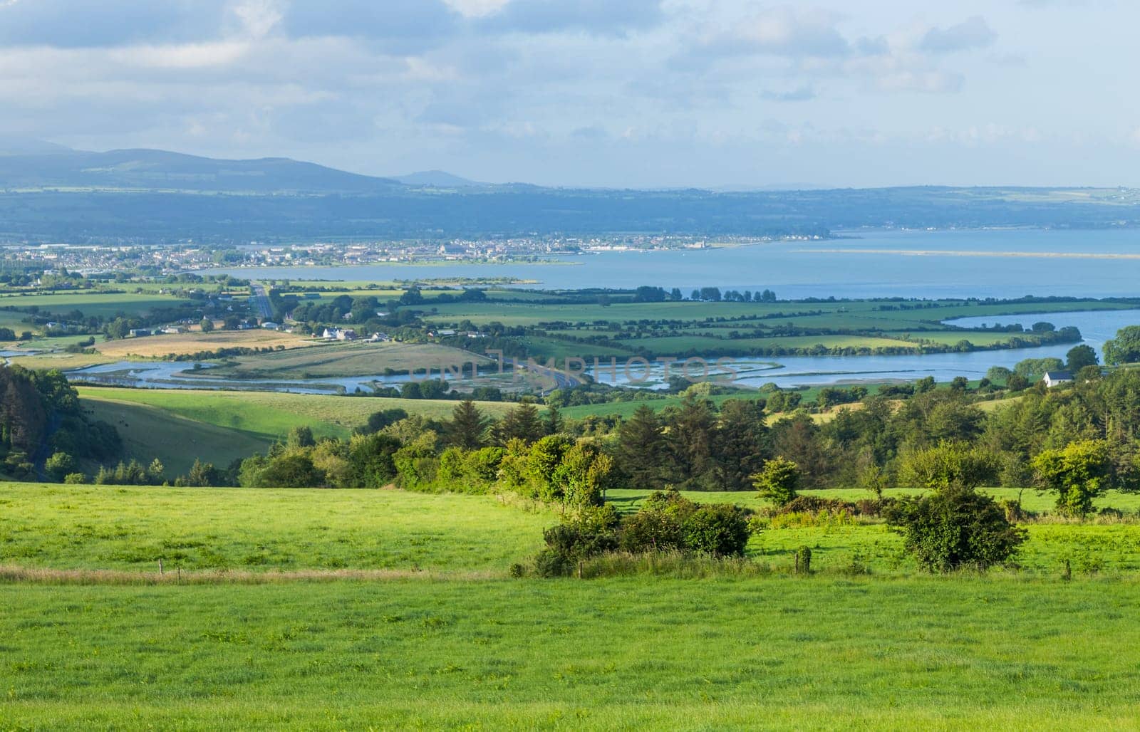Stunning view over countryside, fields, hills and the sea near Dungarvan, Ireland.