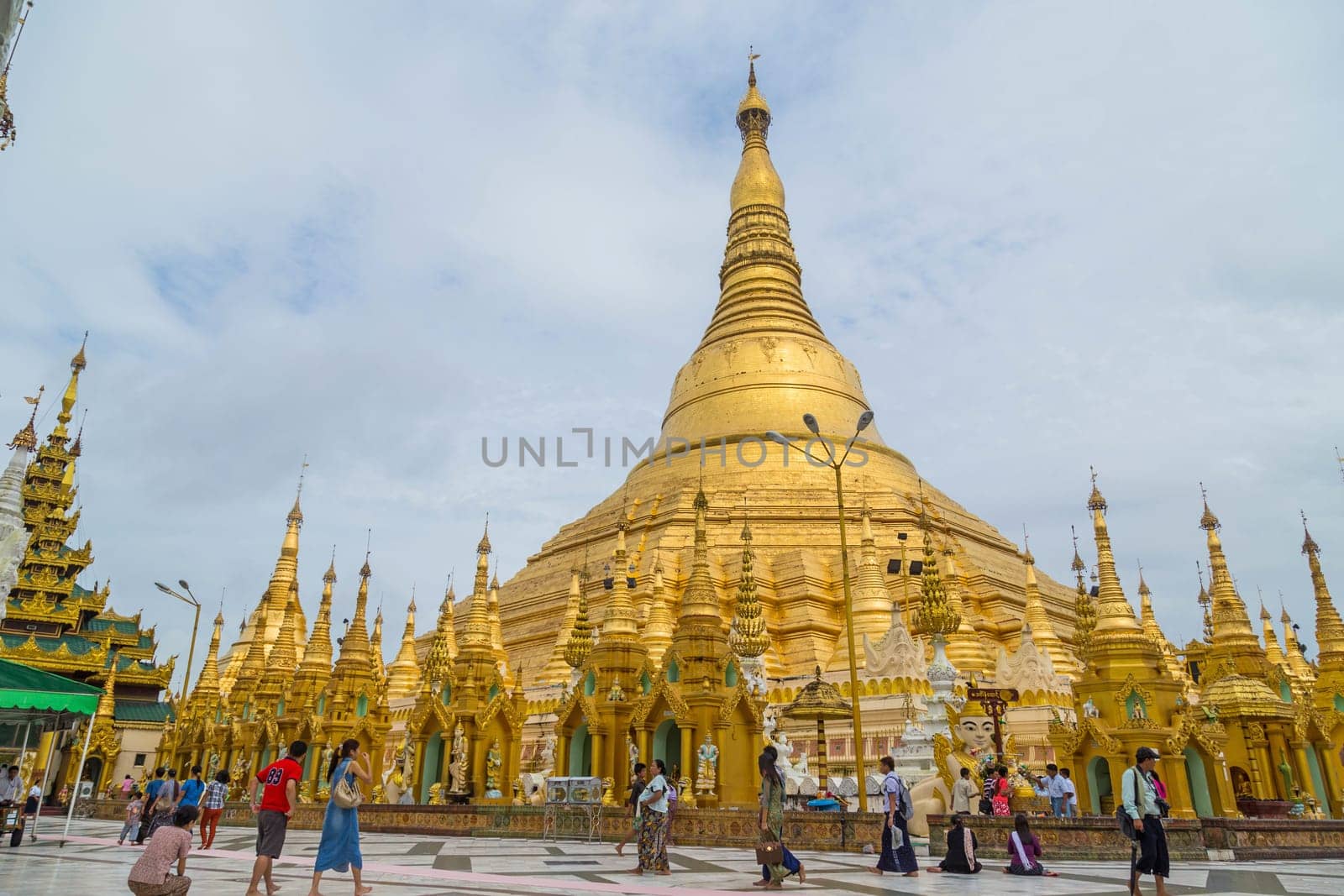 Yangon, Myanmar: 17 August 2020: Worshippers visit Shwedagon Pgoda. Shwedagon Pagoda is the most sacred Buddhist pagoda in Myanmar.