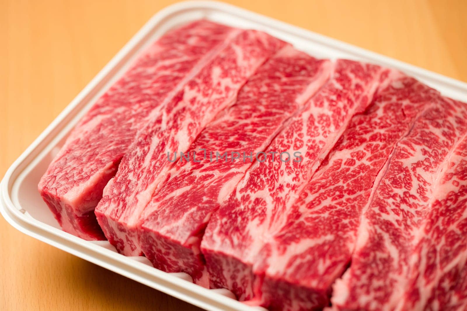 Beef steak in the white plastic container