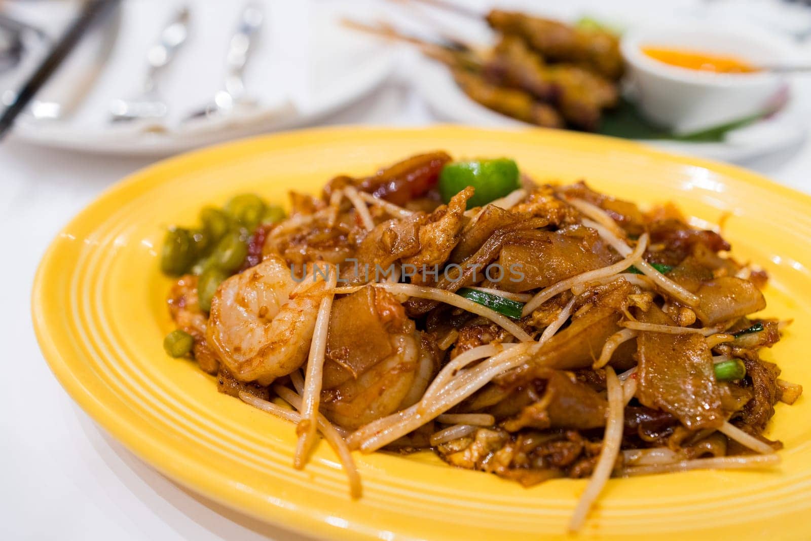 Pan fried flat noodles dish in Thai restaurant