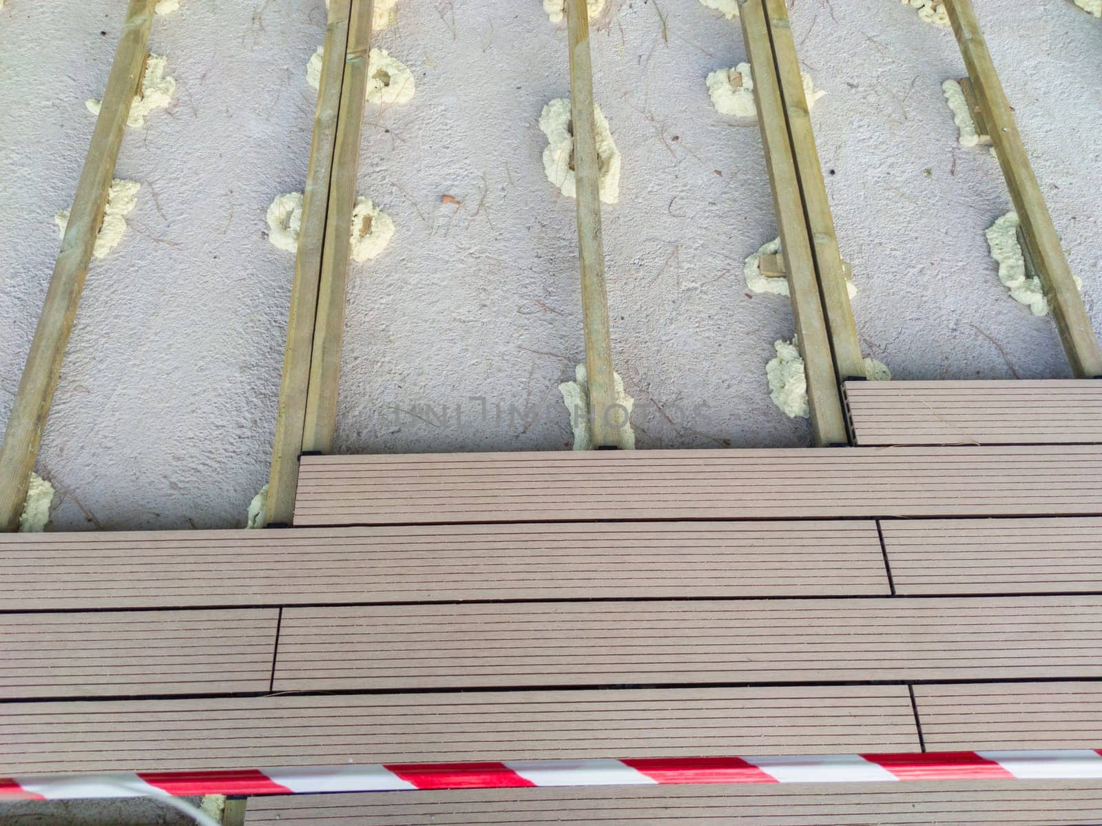 Installation of wooden flooring on a polyurethane foam base. Urban background close to public park