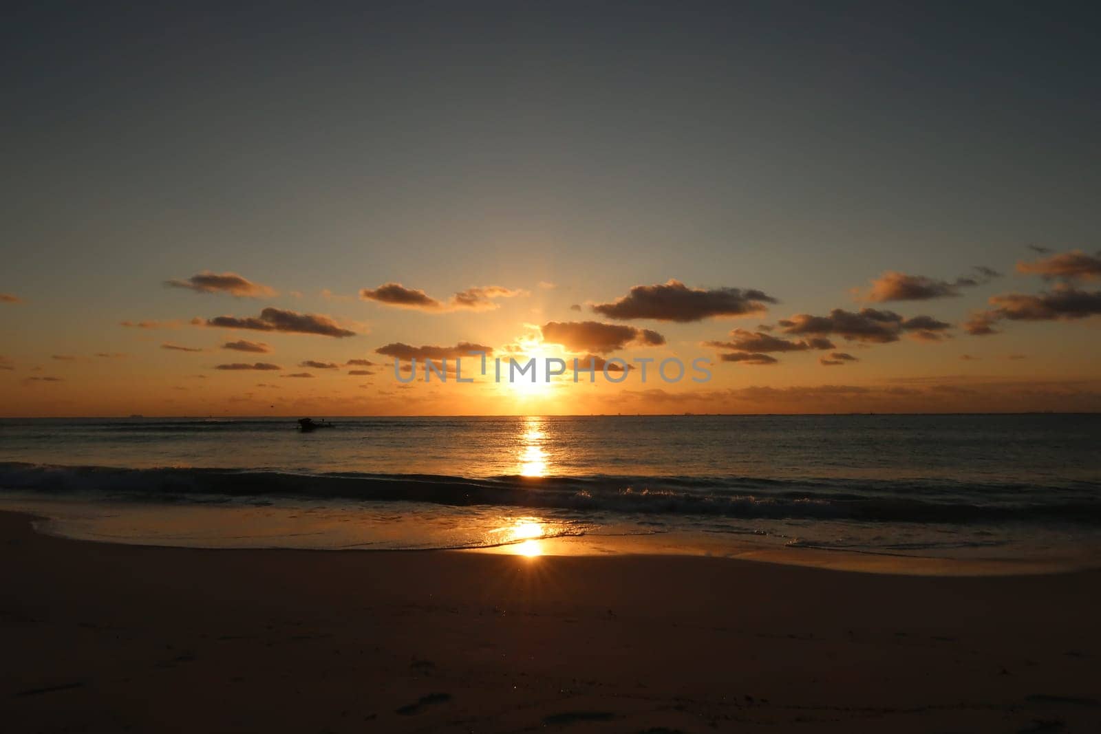Sunrise and its reflection at the beach in playa del Carmen, Mexico 2022