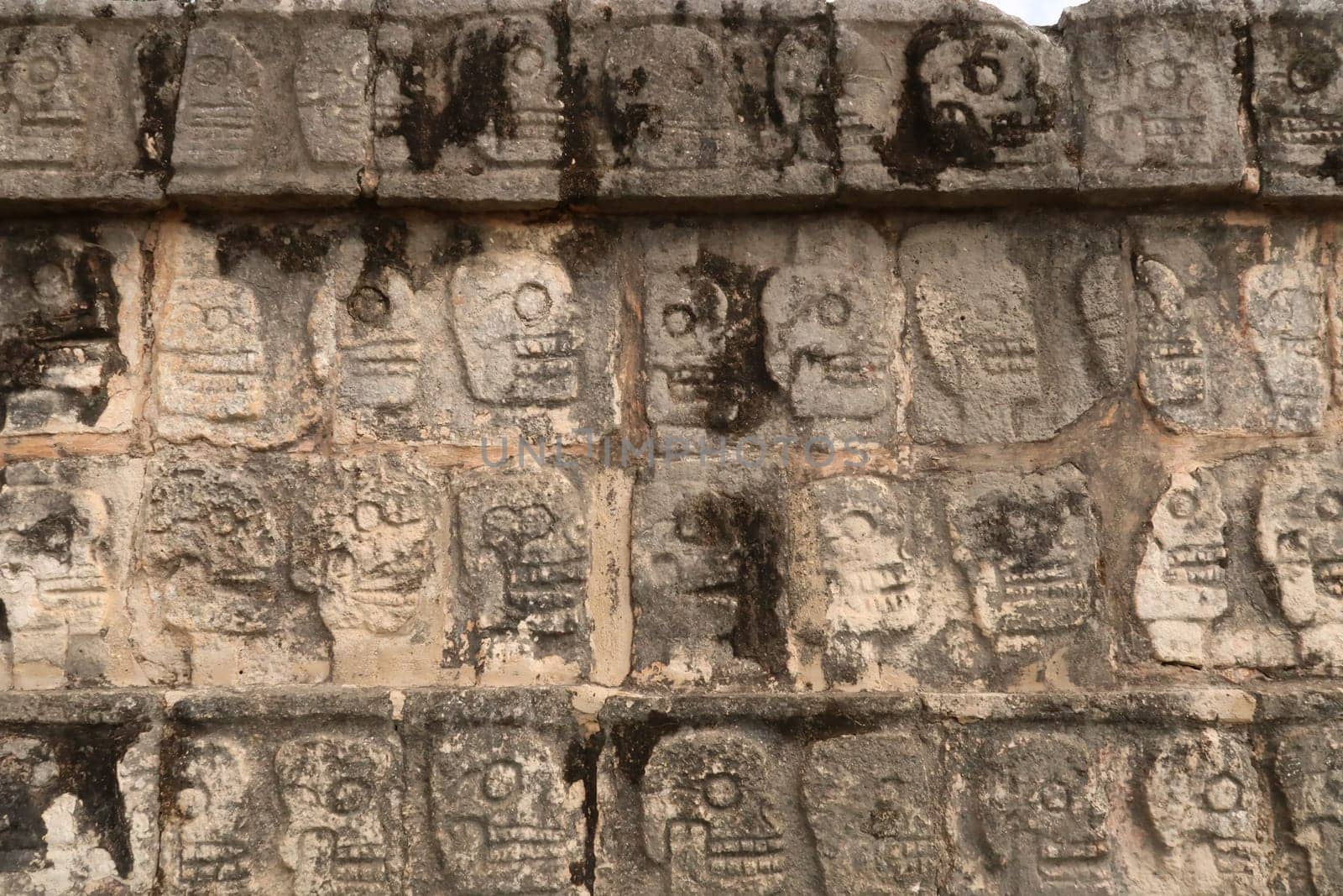 Skull pattern on the Tzompantli, skull platform, plataforma de los craneos, at Chichen Itza, close to Valladolid, Mexico 2022
