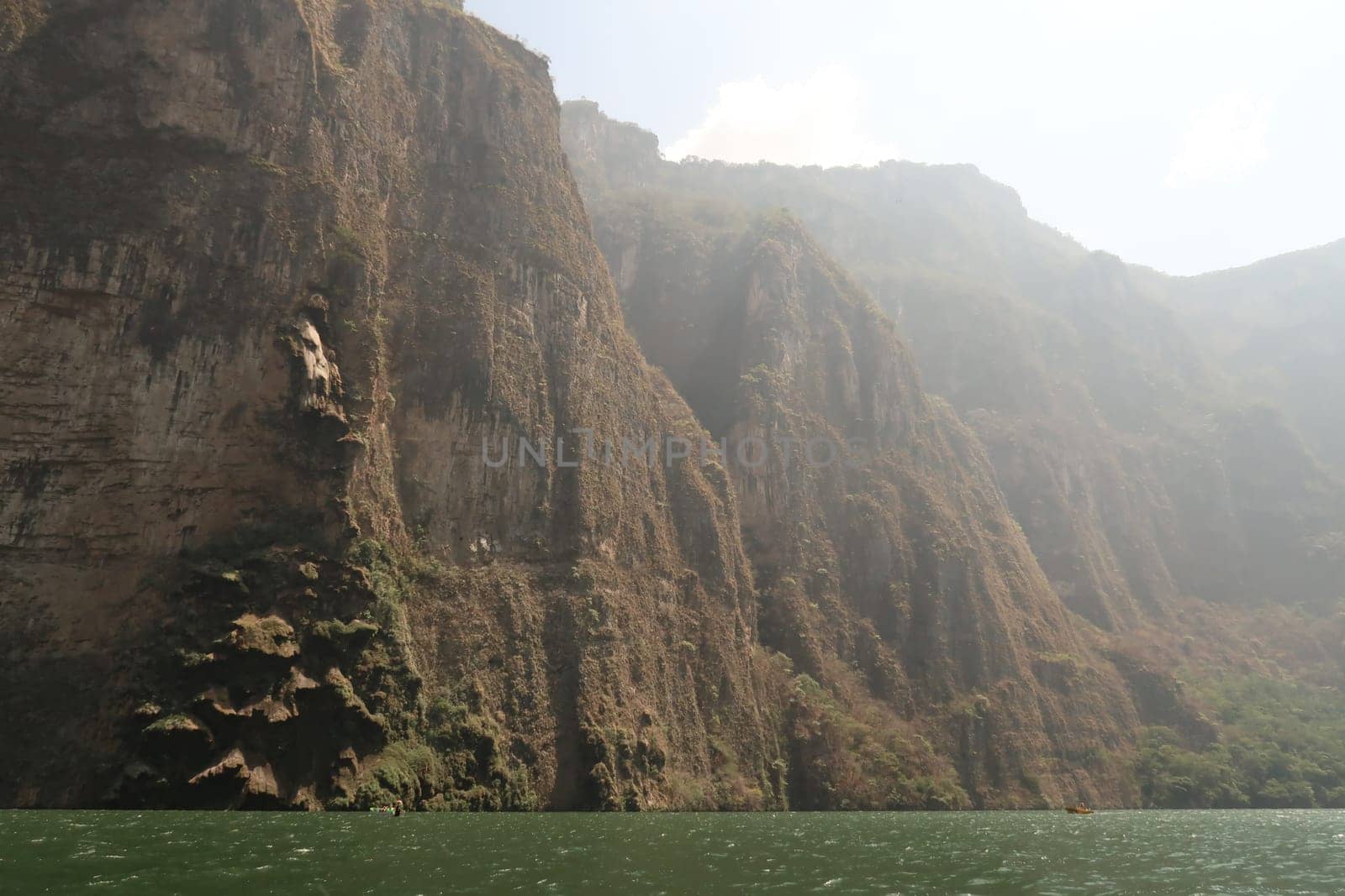 Boats with tourists stopping at the Christmas Tree Waterfall/Cascada Arbol de Navidad at Sumidero Canyon/Canon del Sumidero, Chiapas, Mexico 2022