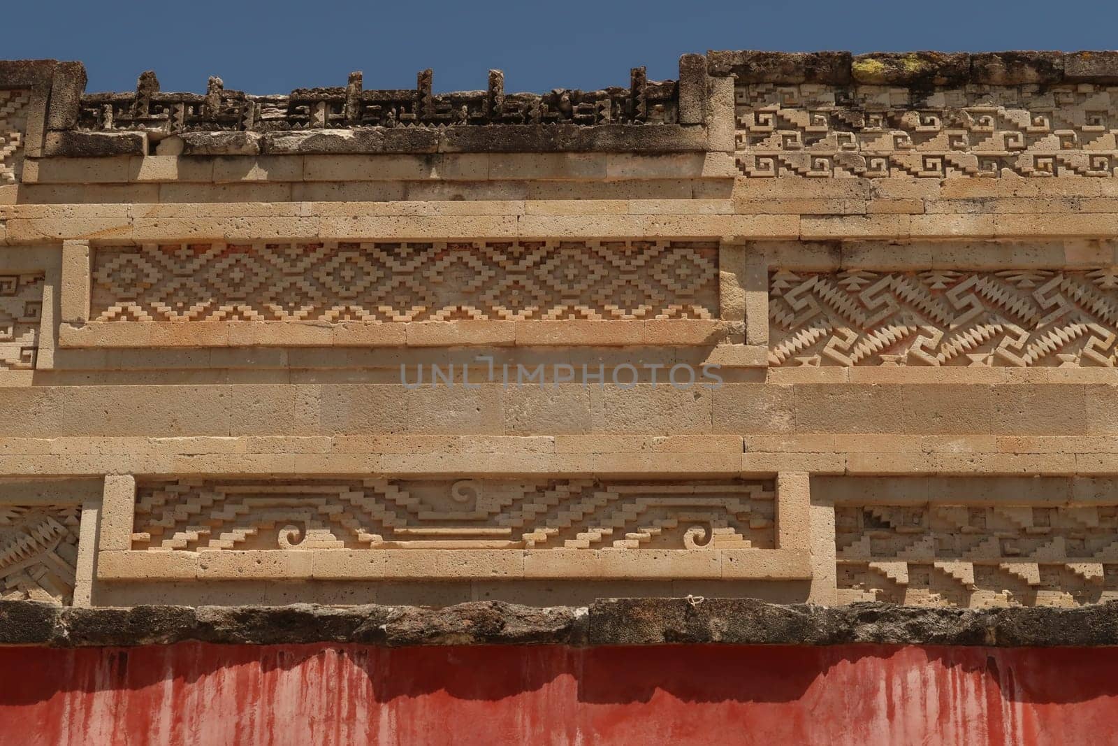Different shapes, carvings, patterns and red colored wall on the southern facade of The Palace/Grand Hall of Columns, Mitla, Oaxaca, Mexico 2022