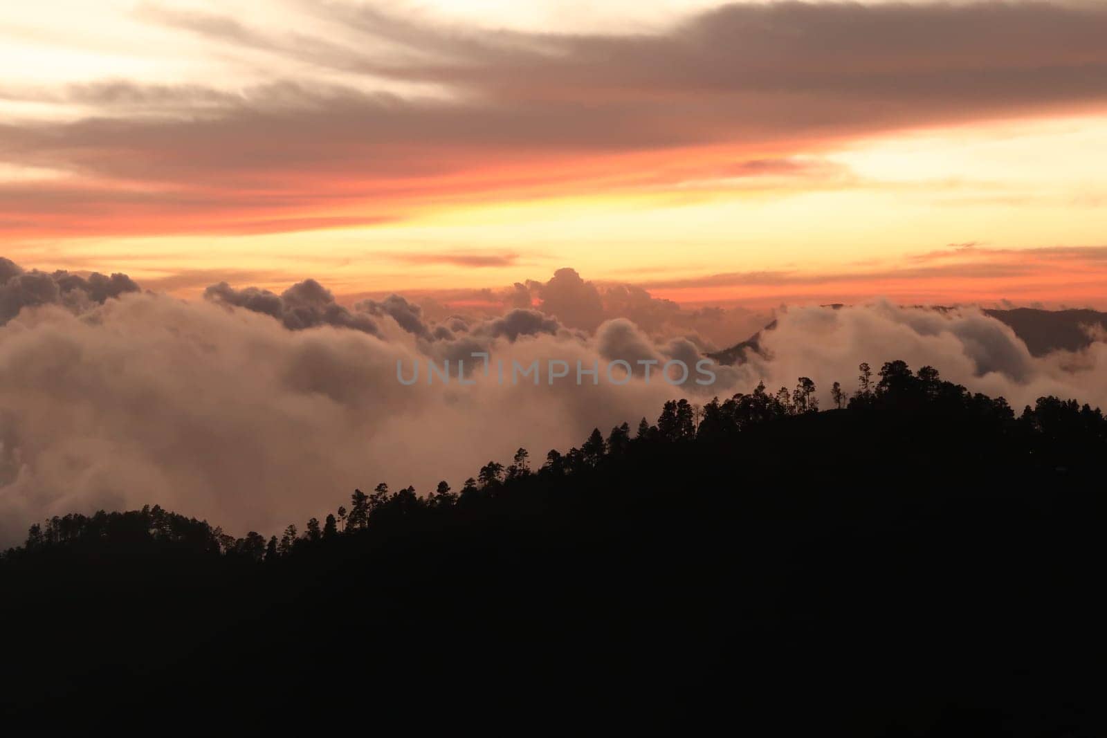 The landscape around San Jose del Pacifico at sunset, clouds, hills and a colorful sky, Oaxaca, Mexico 2022