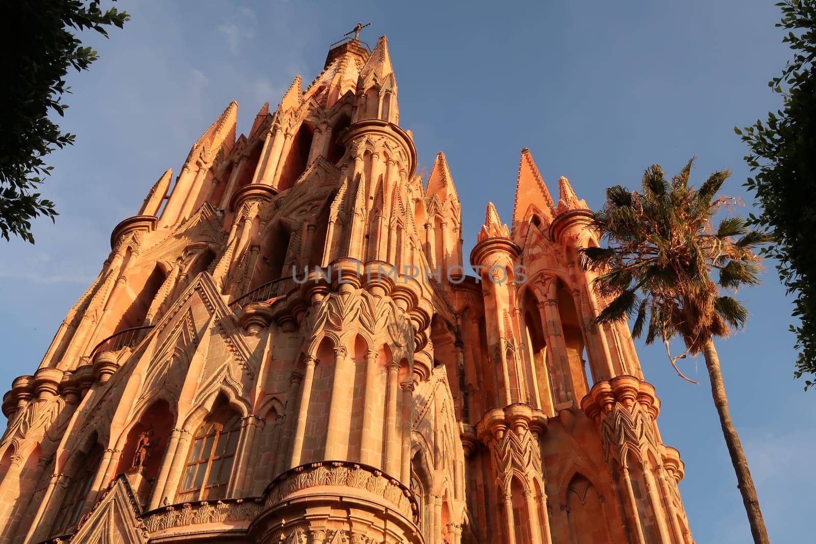 The beautiful upper facade of the church/cathedral Parroquia de San Miguel Arcangel in San Miguel de Allende at sunset, Mexico 2022