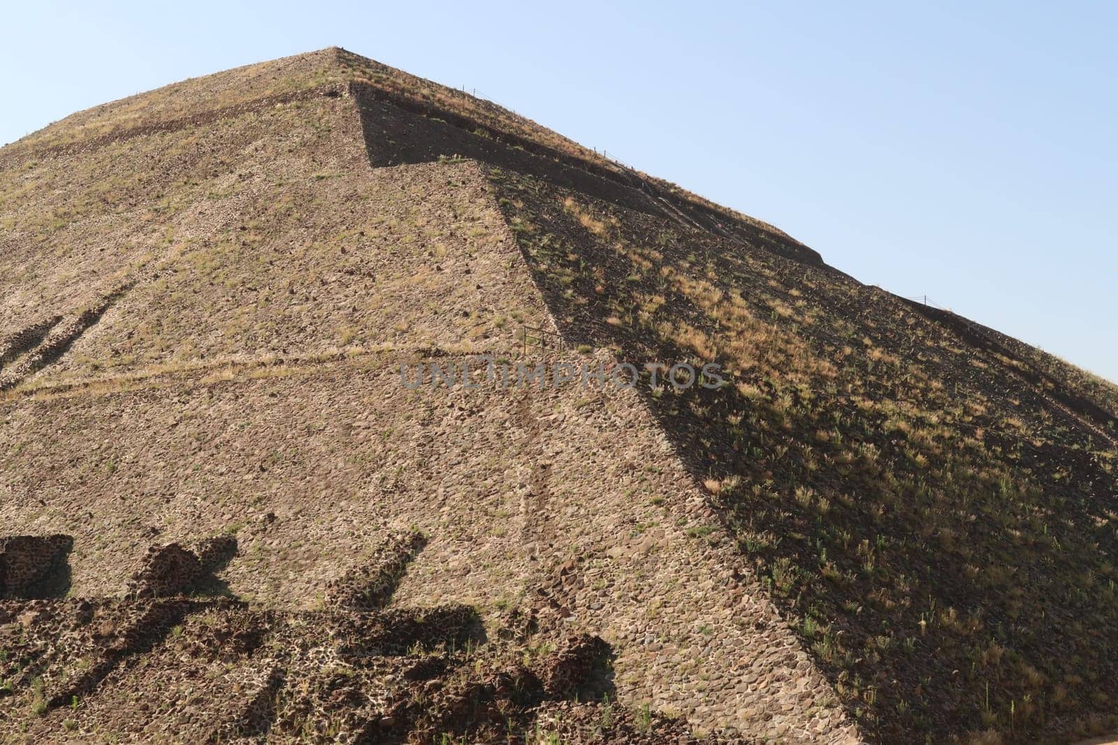 The dry grass is growing on the surface of the giant Pyramid of the Sun at Teotihuacan, Mexico City 2022