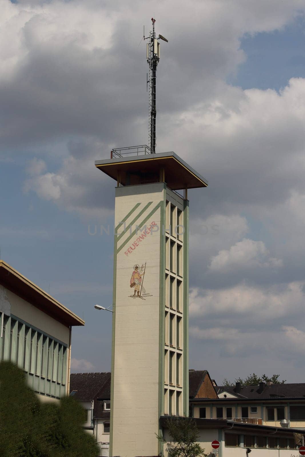 Fire department tower with inscription and transmission tower on the roof in Trier, Germany