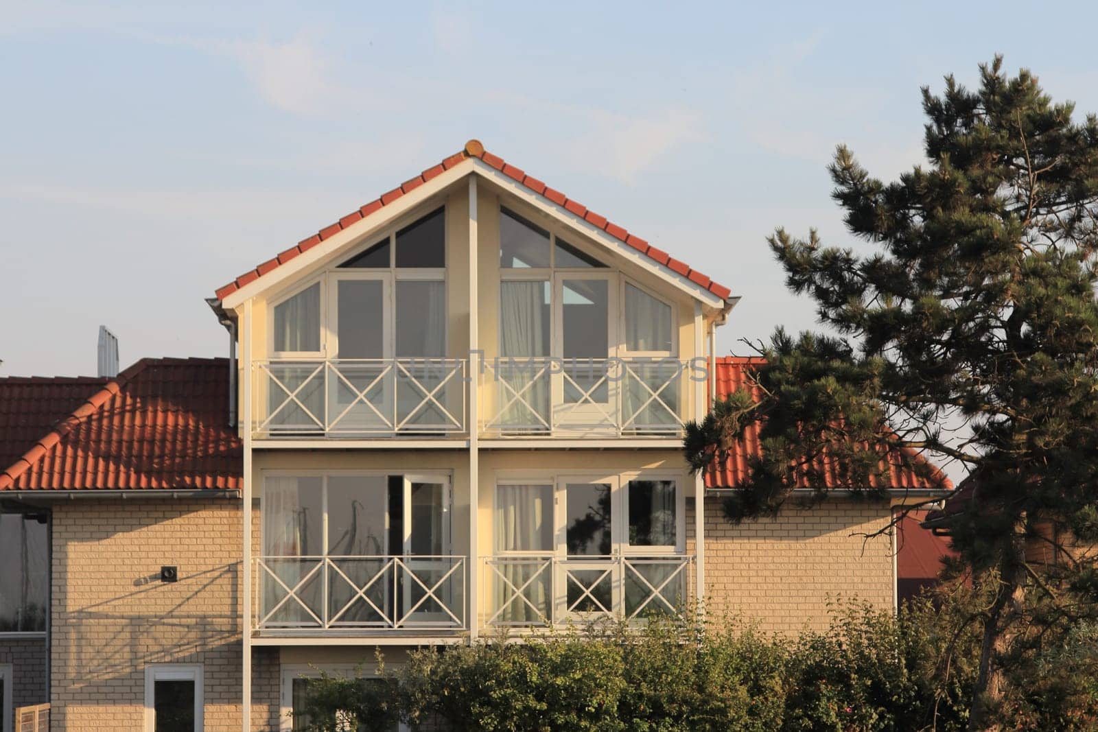 A little beige house with blue sky in the background