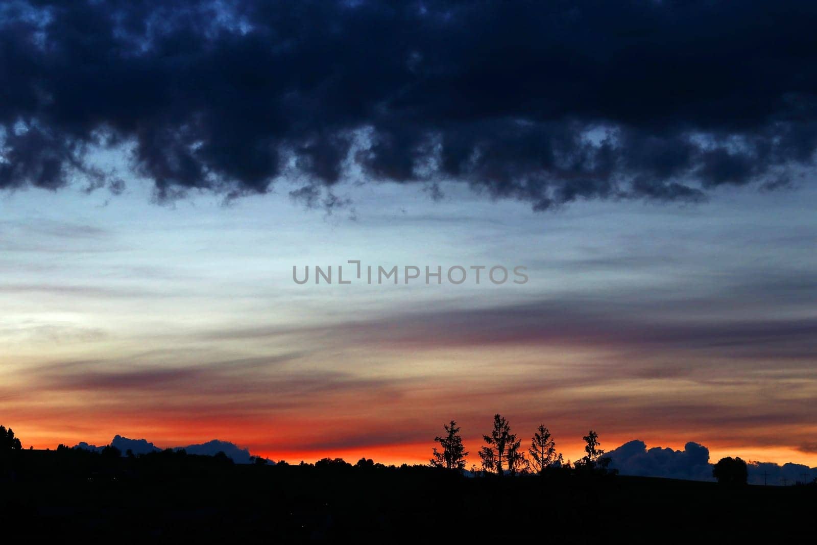 A sunset with dark, eerie rain clouds