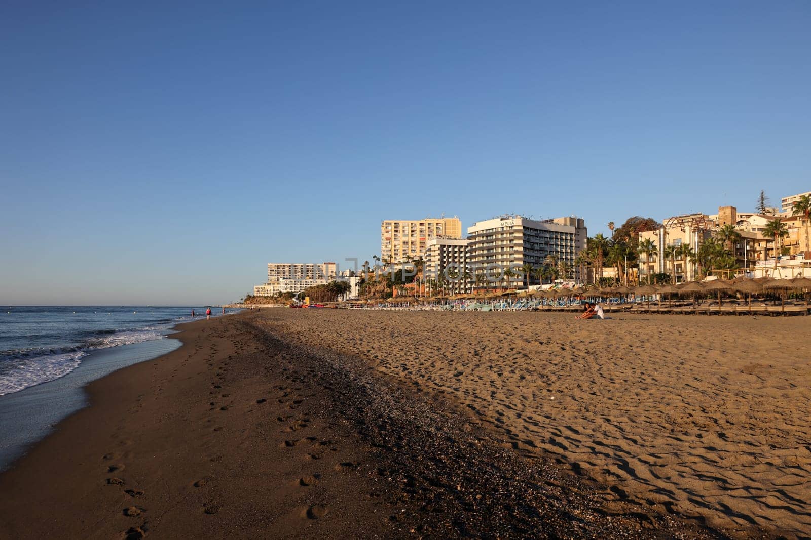 Torremolinos, Spain - September 12, 2023: View of Bajondillo Beach and hotels in Torremolinos at sunrise. Costa del Sol, Spain.