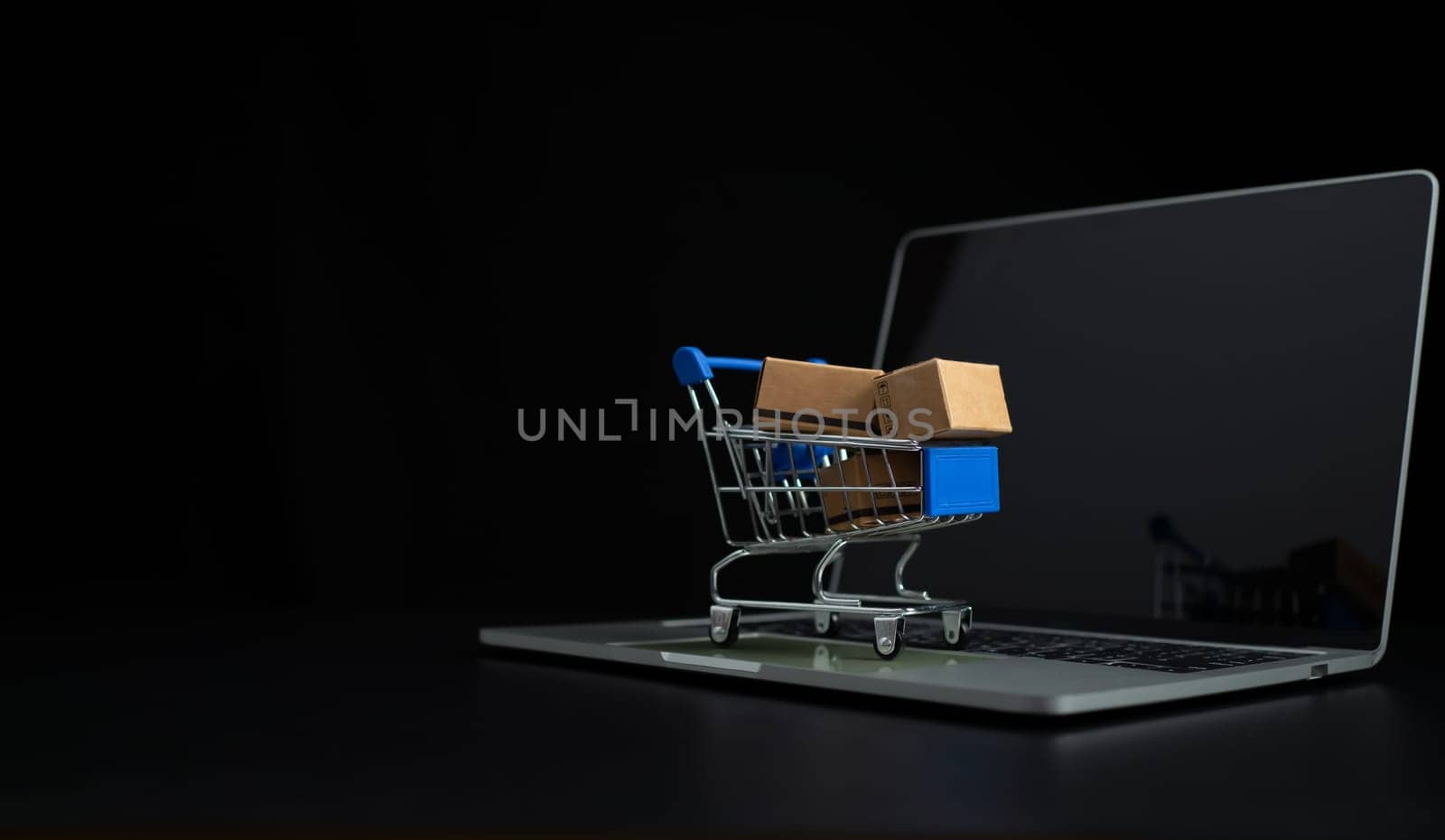 Boxes in a shopping car on a laptop keyboard. Ideas about online shopping, online shopping is a form of electronic commerce that allows consumers to directly buy goods from seller over the internet.