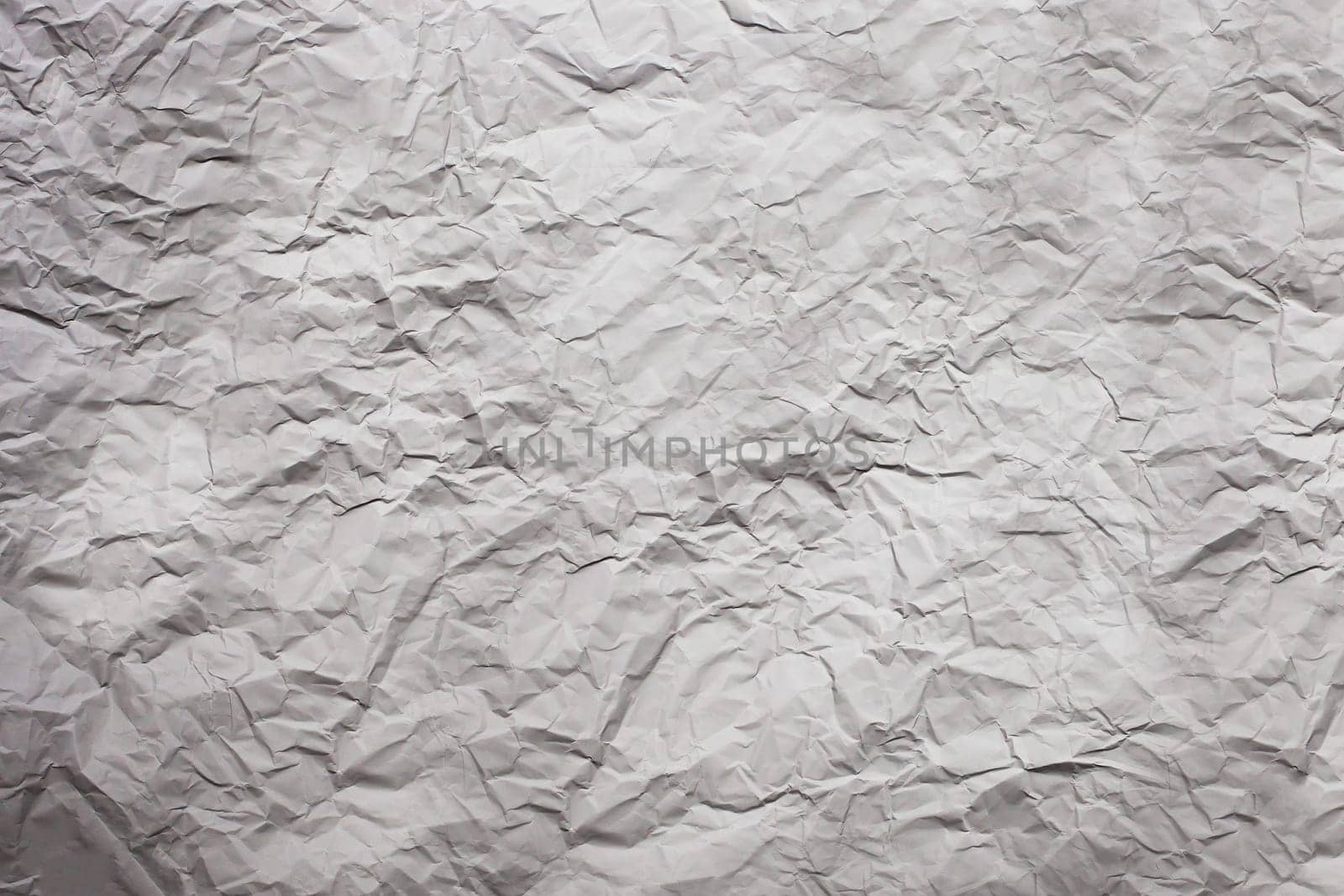 Strongly rumpled paper of gray color. Texture. Background