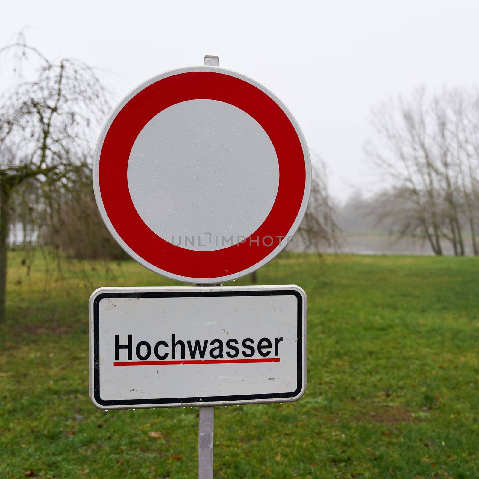 Path closed due to flooding on the banks of the River Elbe in Magdeburg in Germany in January 2024. Translation on the sign: High water