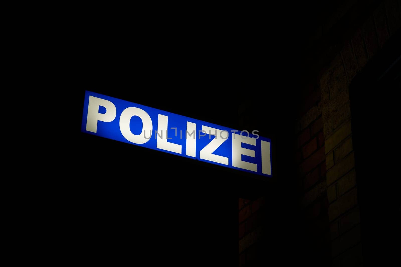 Neon light of a german police station in the port of Stralsund at night