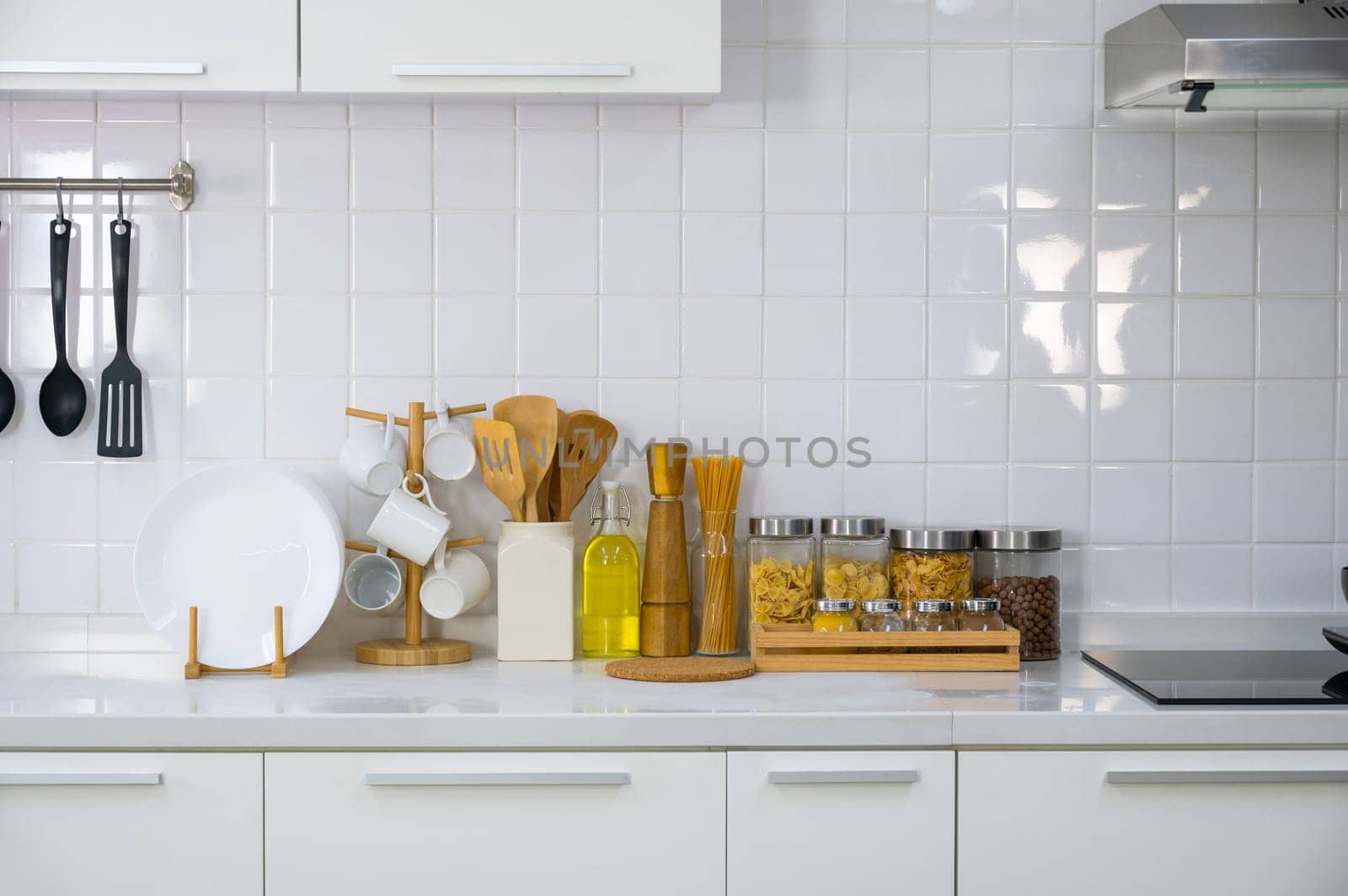 Kitchen utensils on white countertop, stove culinary background, wooden and white ceramic kitchenware. Home healthy cooking concept