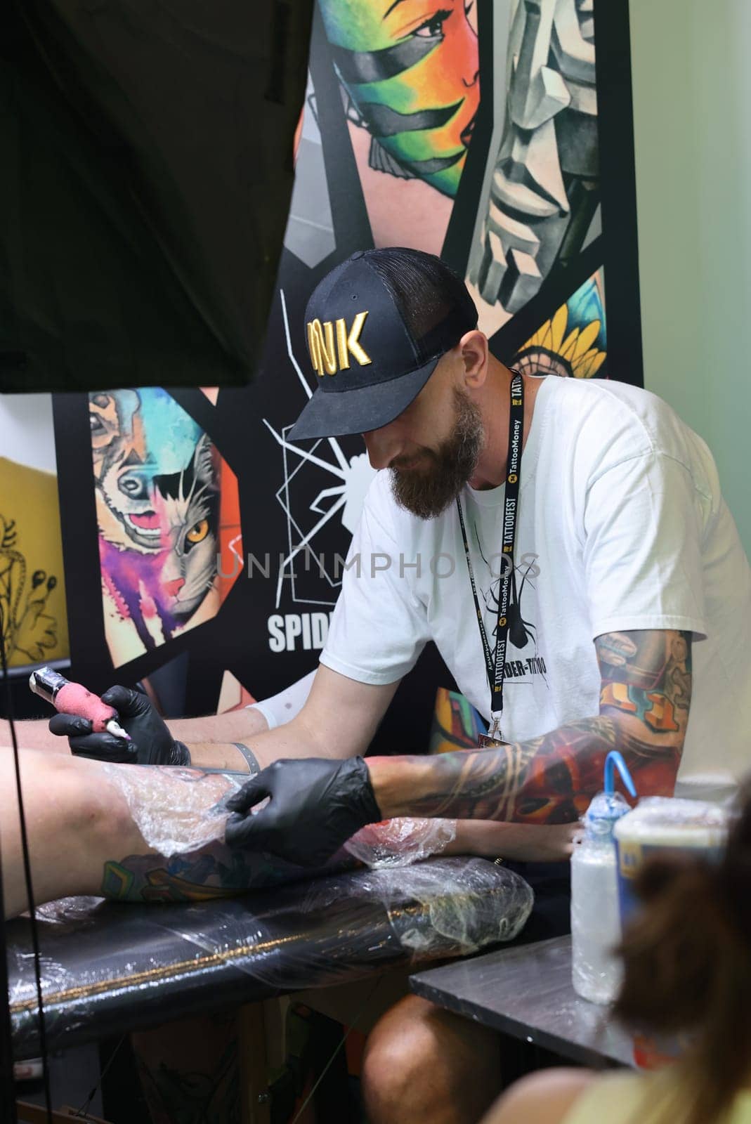Krakow, Poland -  June 12, 2022: Unidentified  participant at 15th Tattoofest Convention in Cracow. One of the most prestigious tattoo festivals. Tattoo artist at work.