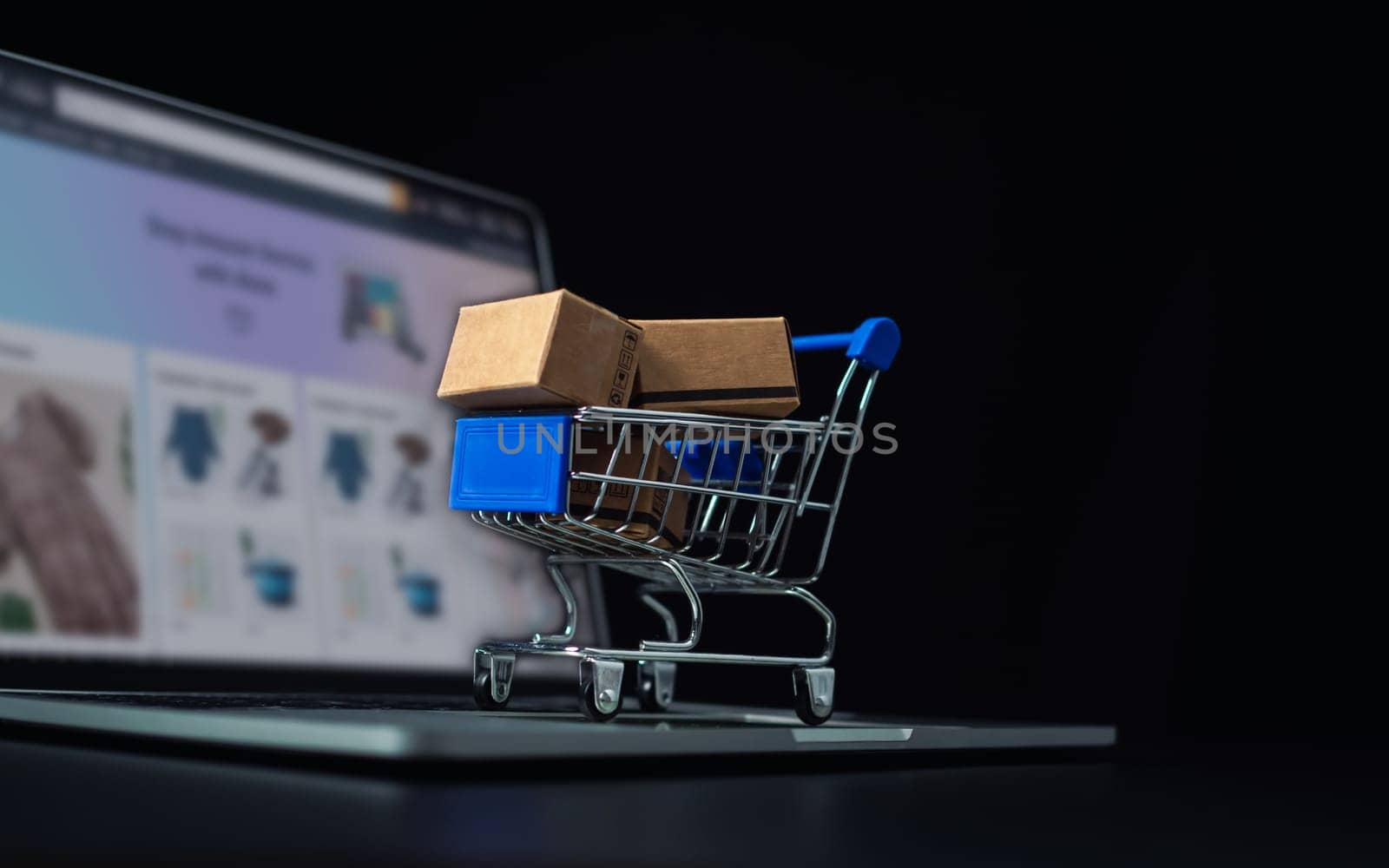 Boxes in a shopping car on a laptop keyboard. Ideas about online shopping, online shopping is a form of electronic commerce that allows consumers to directly buy goods from seller over the internet.