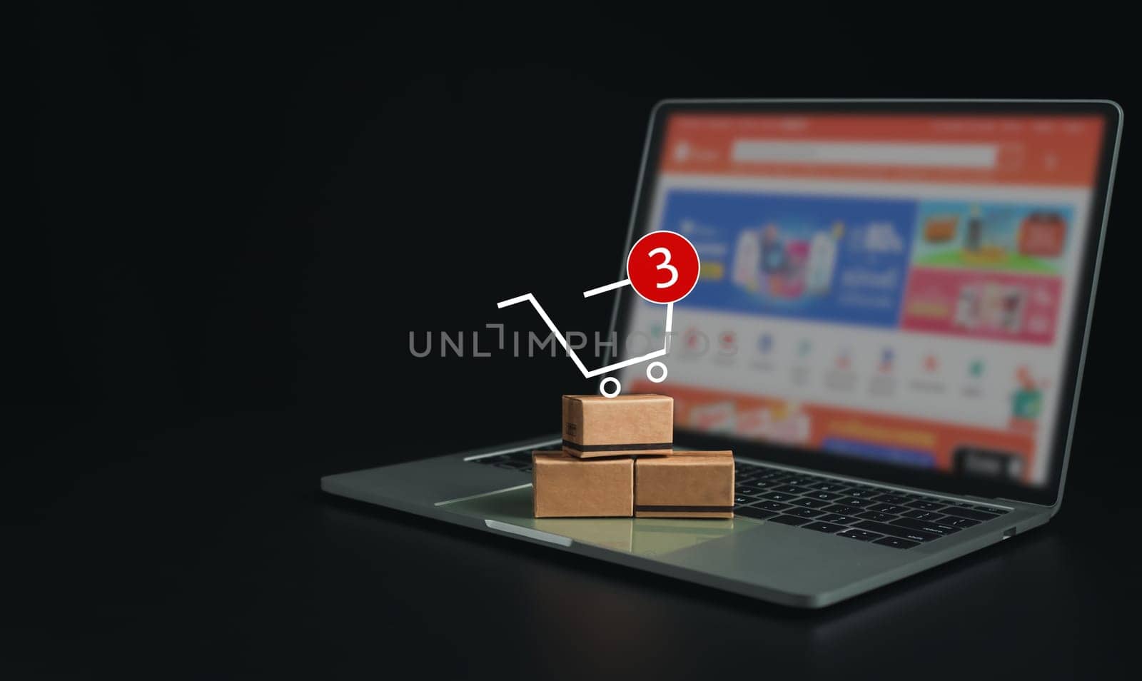 Boxes on a laptop keyboard on dark background. Ideas about online shopping, online shopping is a form of electronic commerce that allows consumers to directly buy goods from seller over the internet.
