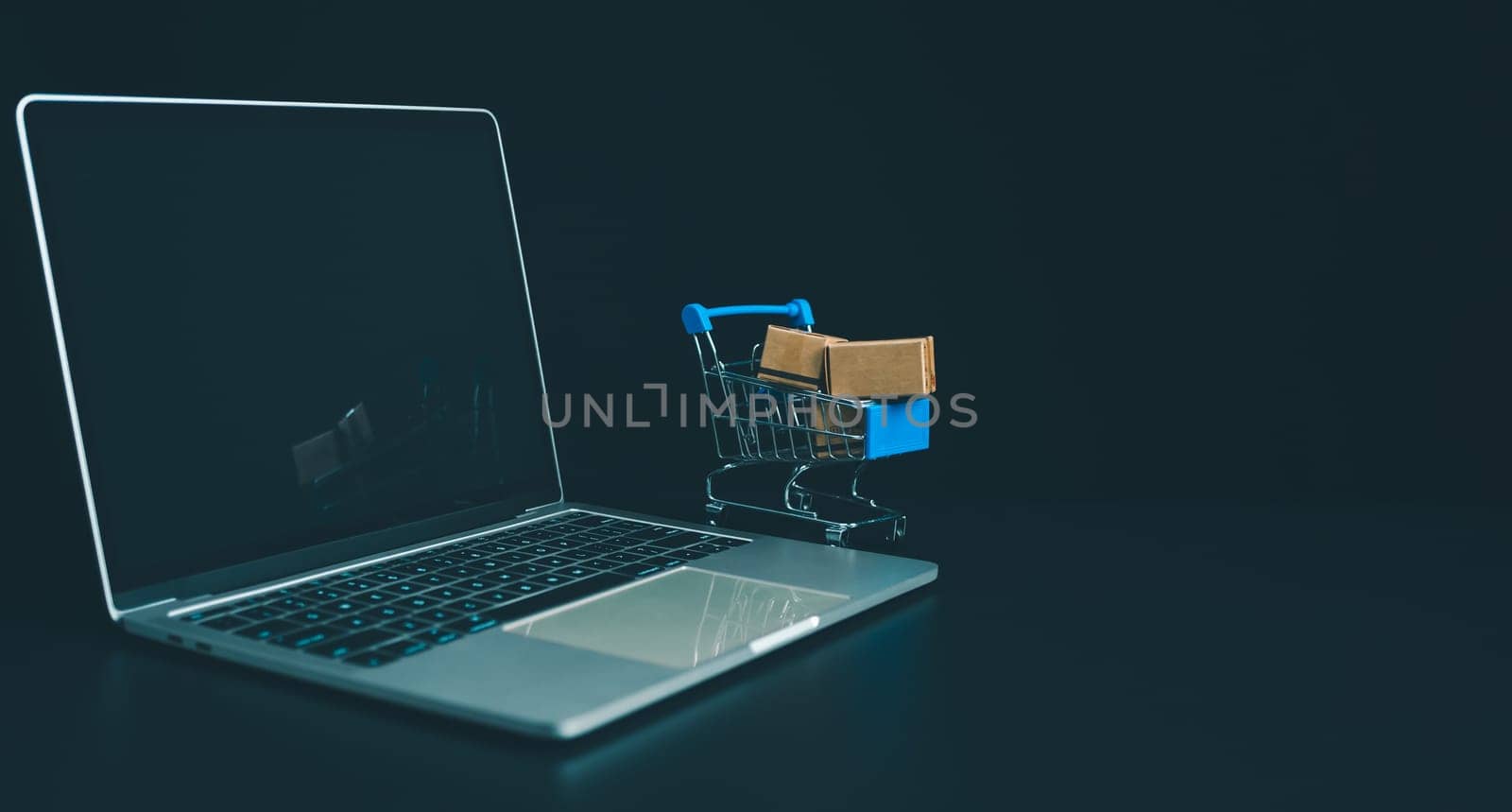 Boxes in a shopping car on a laptop keyboard. Ideas about online shopping, online shopping is a form of electronic commerce that allows consumers to directly buy goods from seller over the internet.