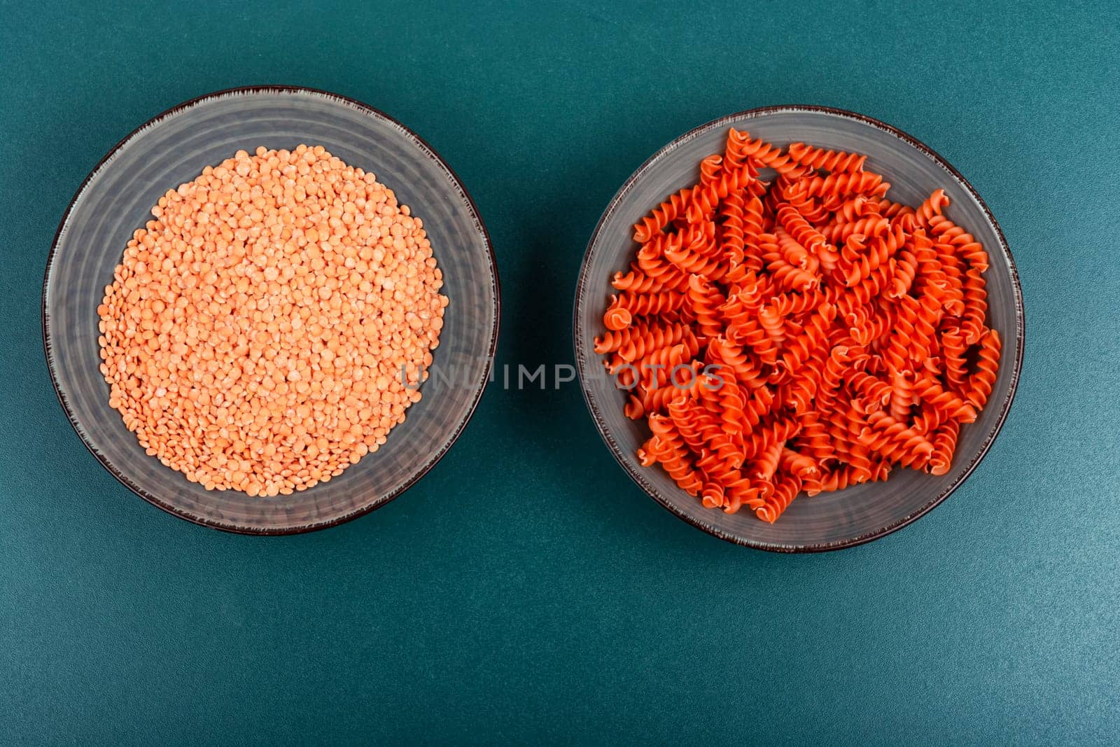 Dry red lentil fusilli pasta. Uncooked vegan pasta. Italy cuisine. Space for text.