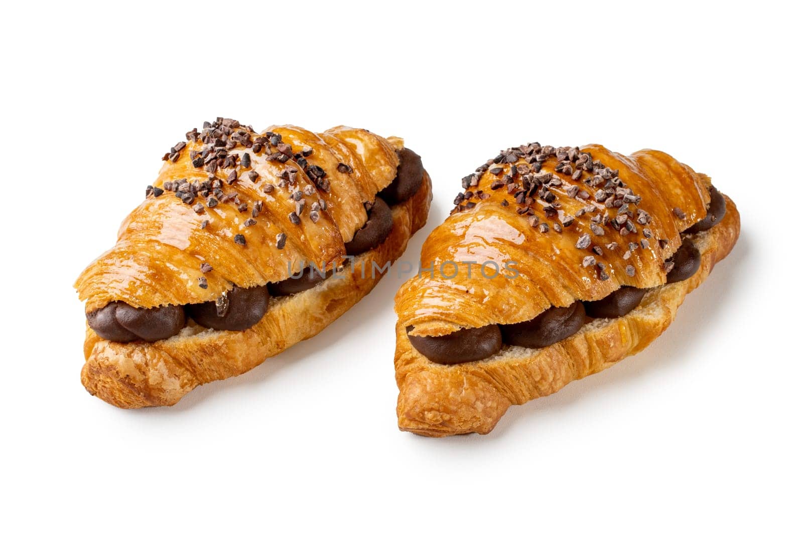 Delight in the flaky goodness of two chocolate-filled croissants. The rich cocoa layers offer a gourmet treat, ideal for showcasing French pastry mastery. This image captures indulgence and quality
