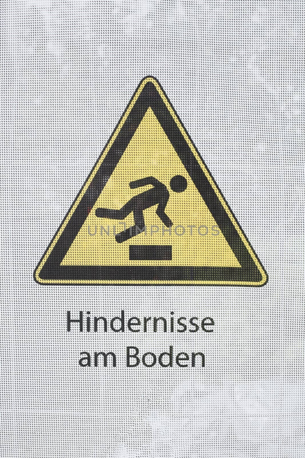 Yellow warning sign Stolpergefahr, obstacles on the ground, Germany