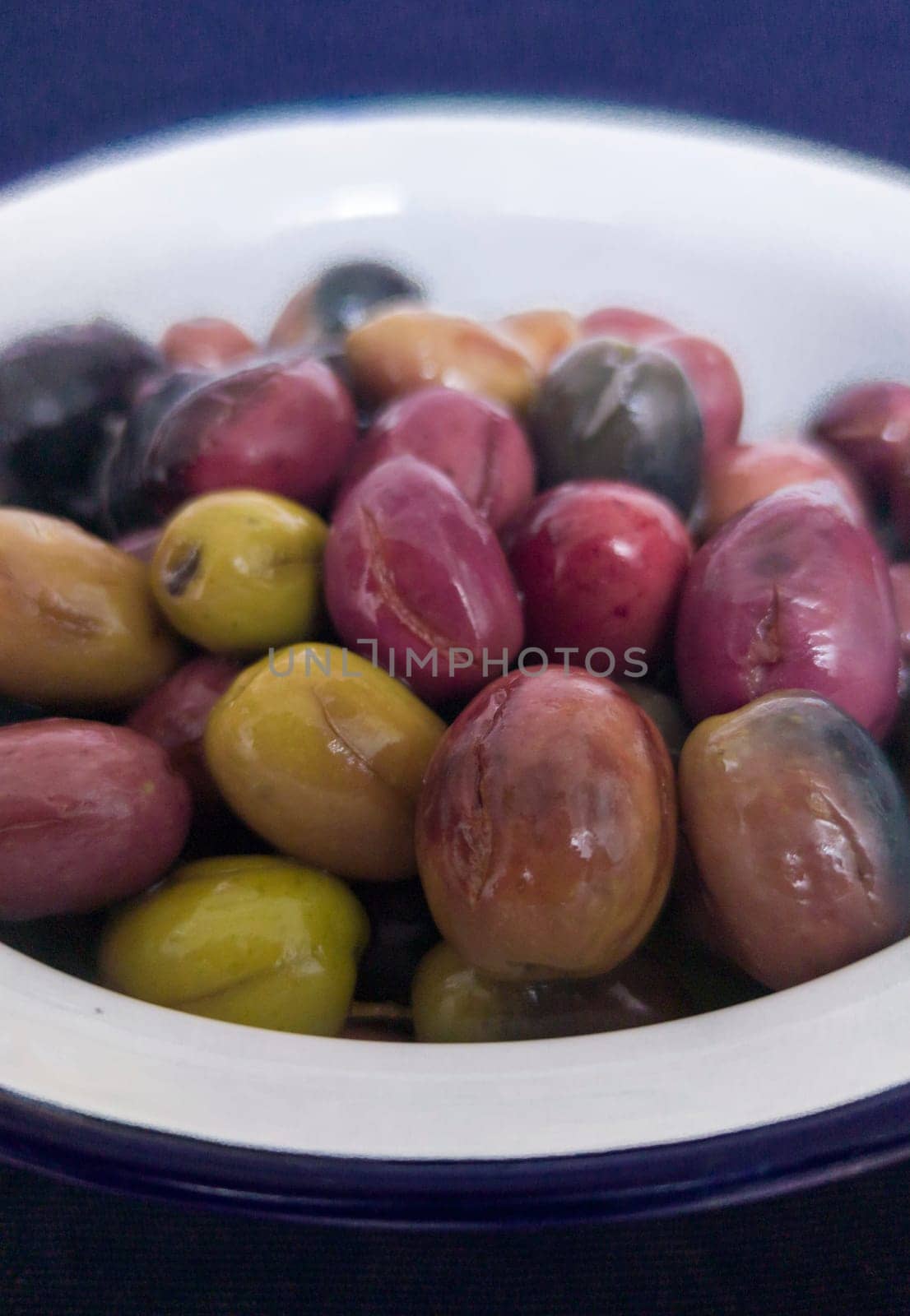 Ceramic bowl filled with cut pickled olives. Traditional method with the purpose of naturally eliminating the bitterness