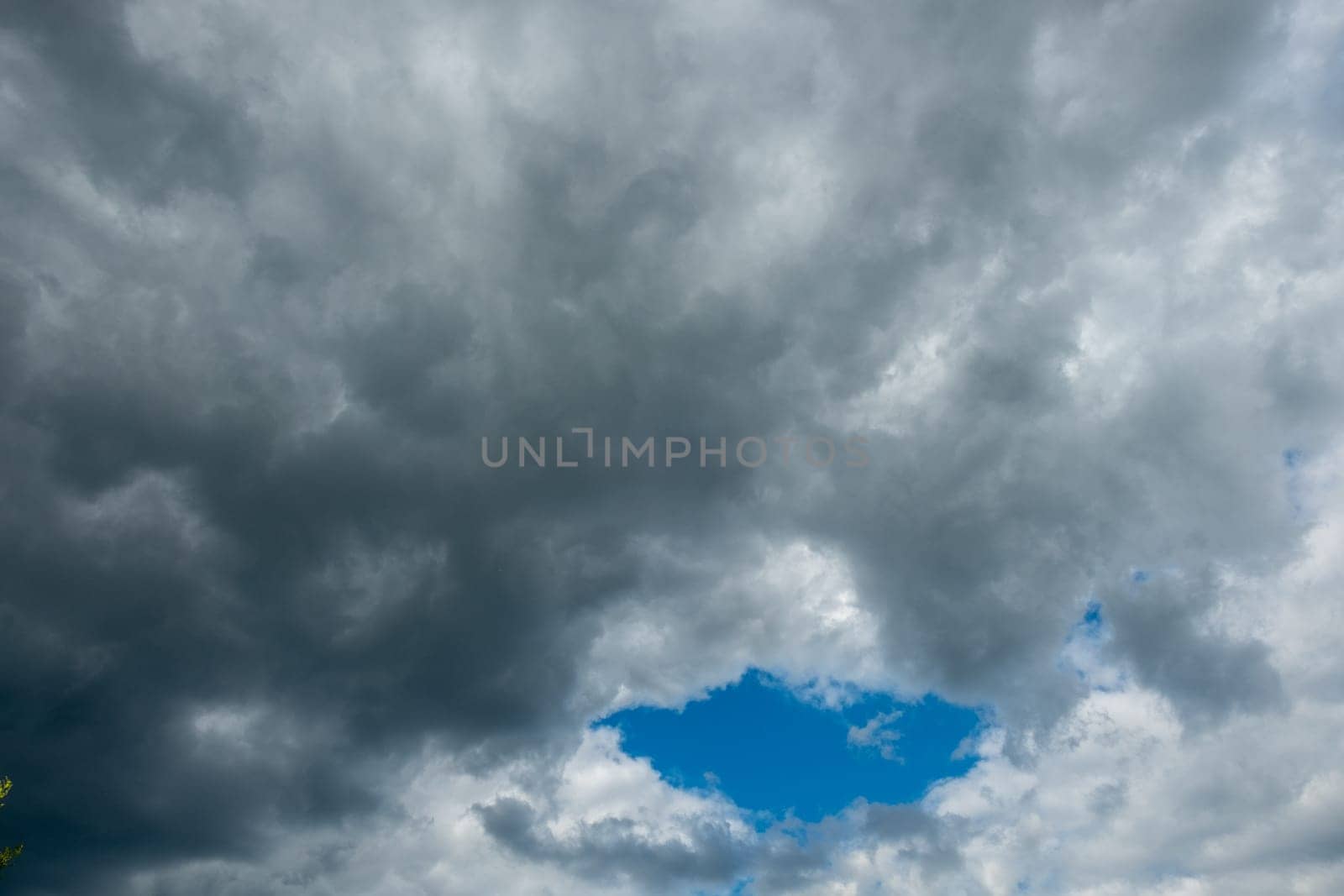 pattern of dark clouds with partly blue sky gives a creepy mood