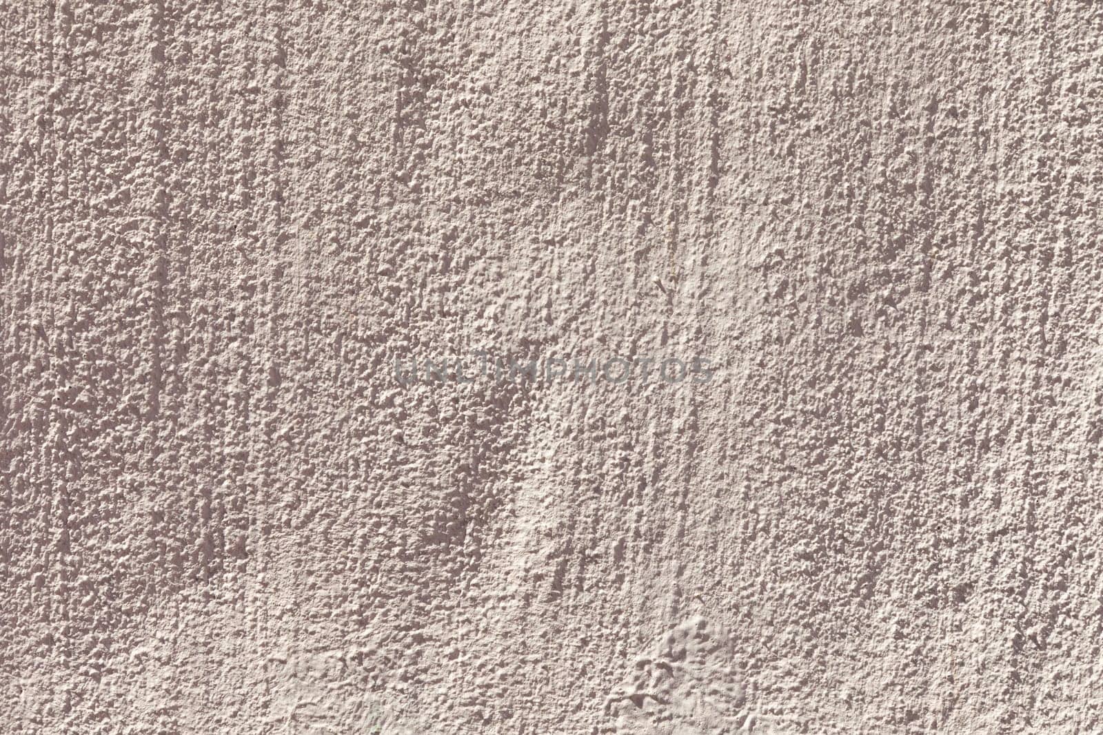 old plaster wall textured with lines in light red color