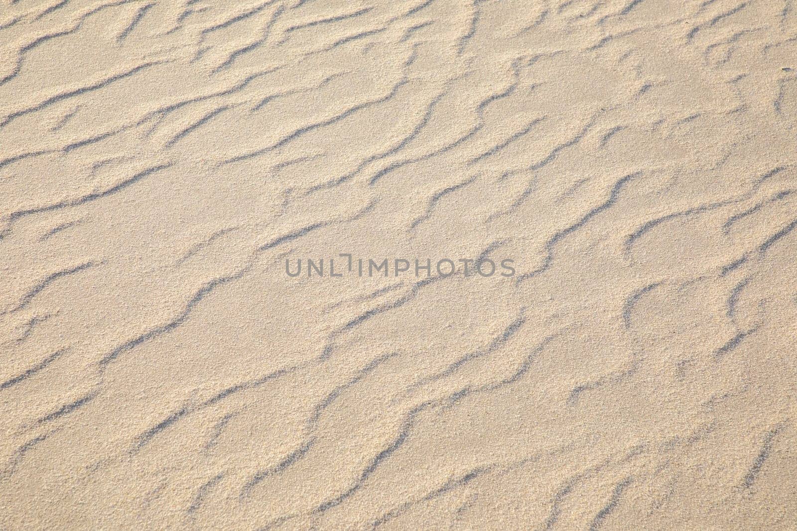 background of beautiful harmonic sandy beach with soft waves