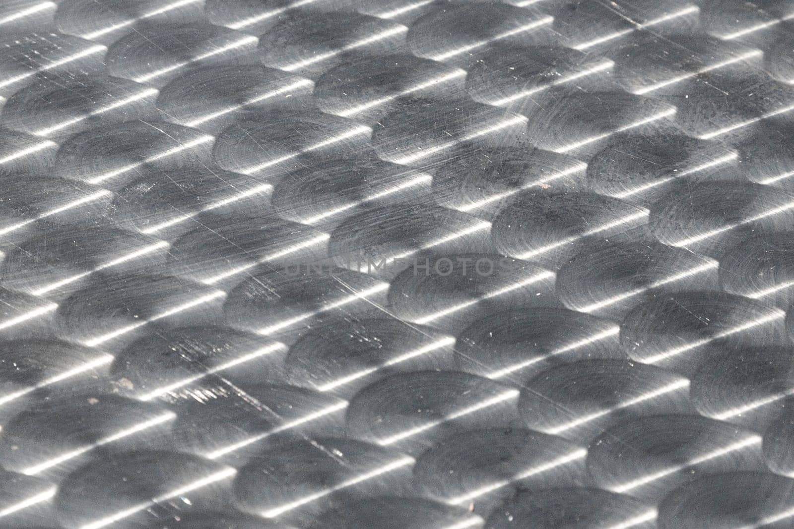 pattern of brushed silver plate with sun reflection gives a harmonic background