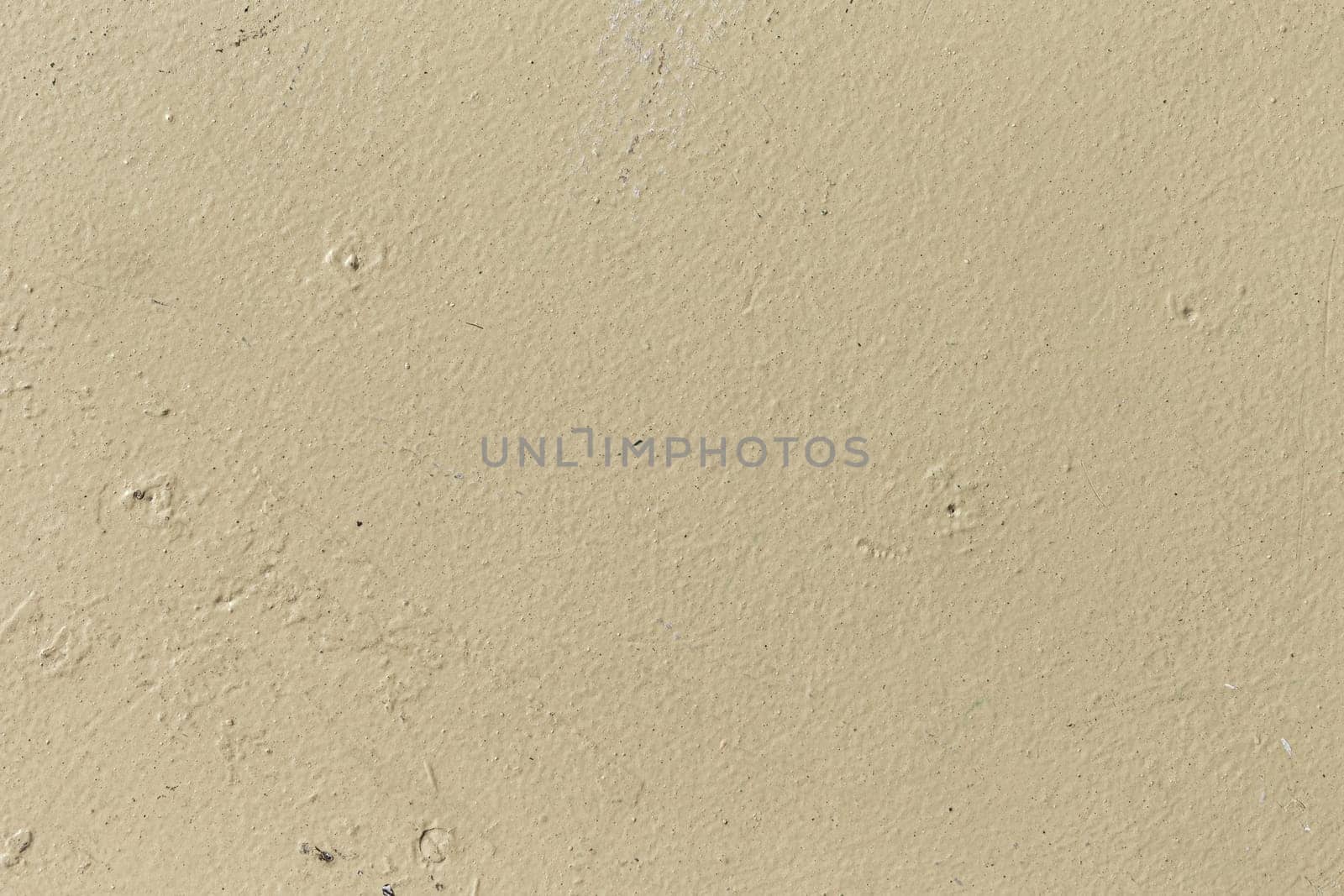 pattern of ochre painted old wall with irregularities