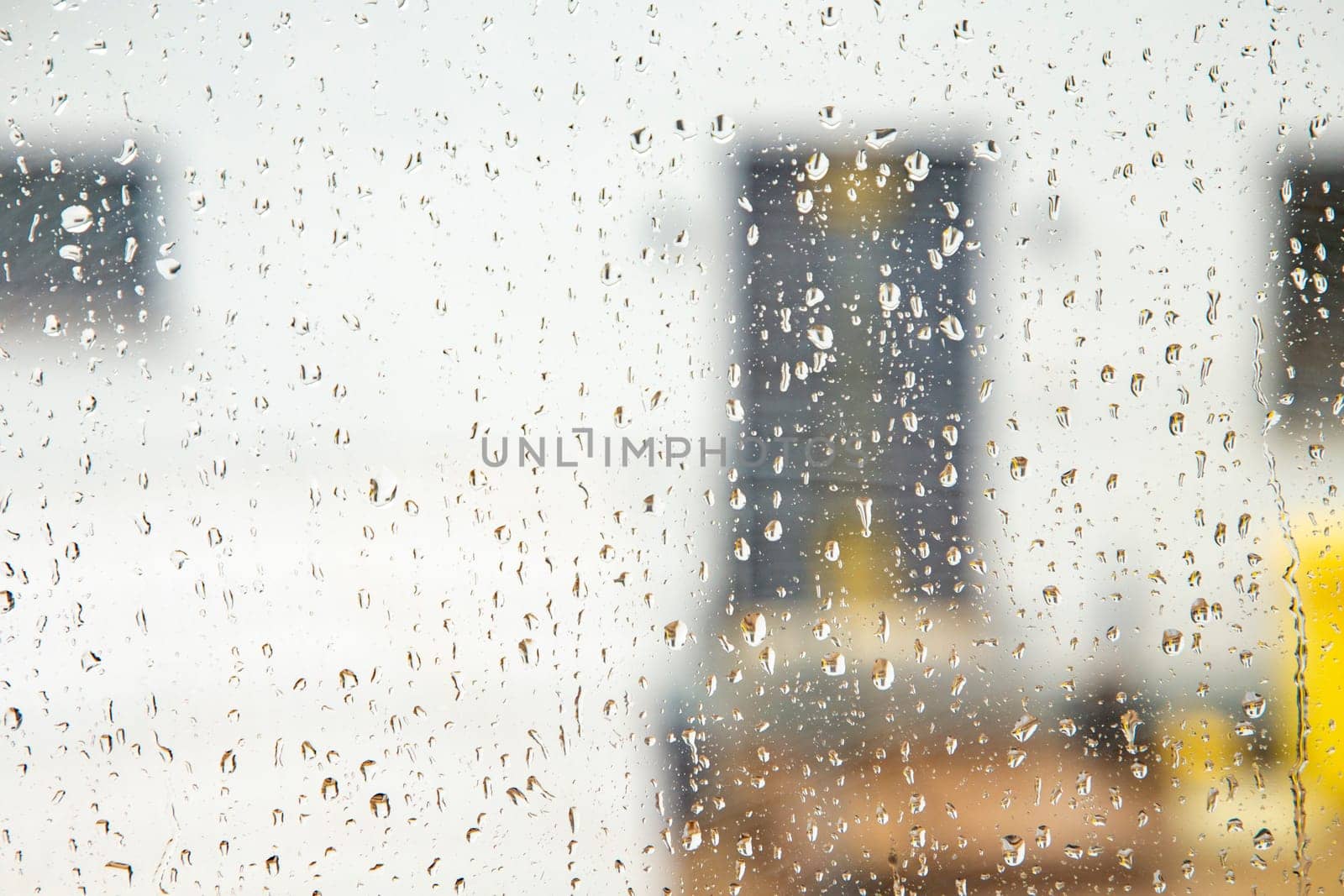 pattern of raindrops at the window in heavy rain