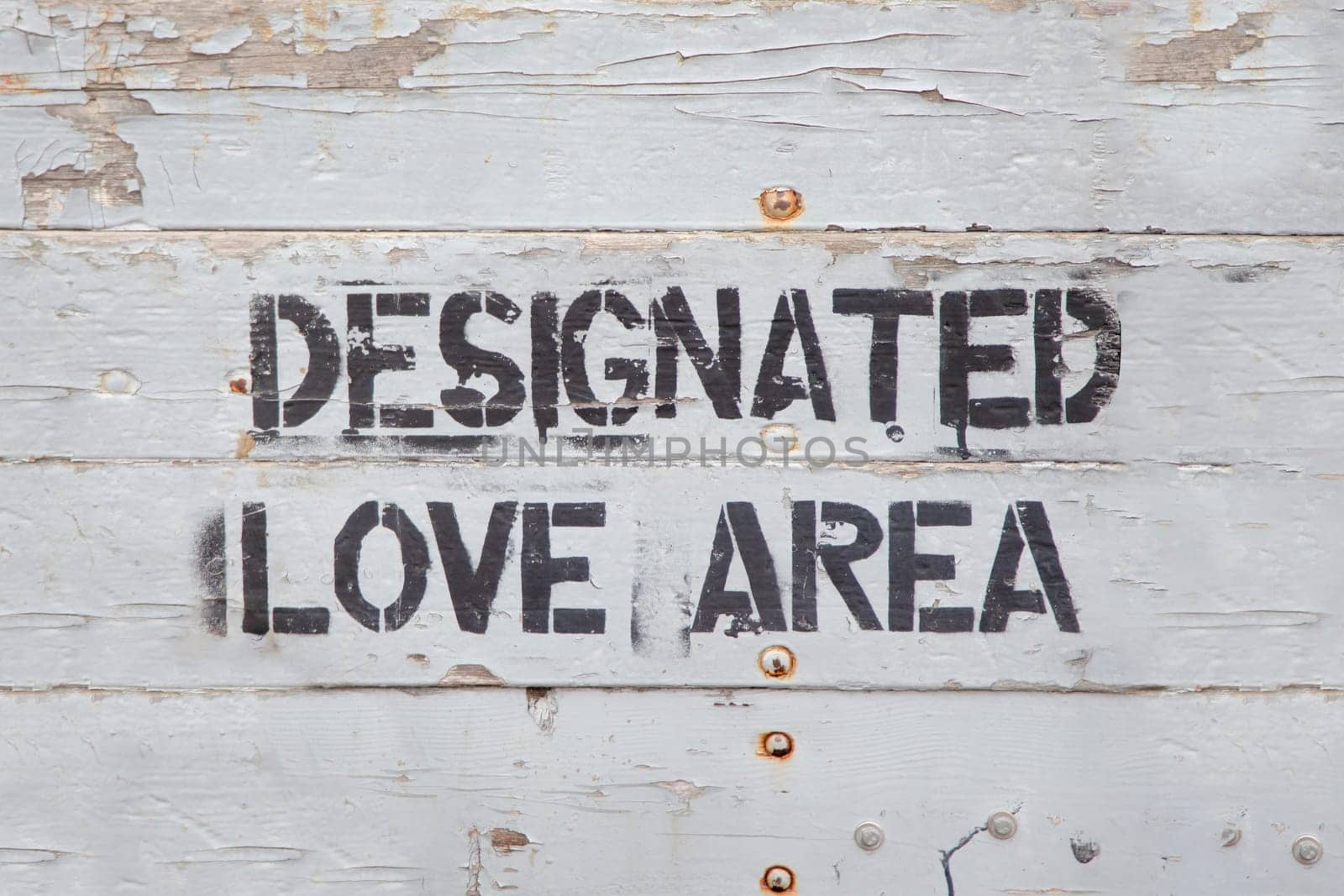 sign designated love area painted at a grey wall as love symbol