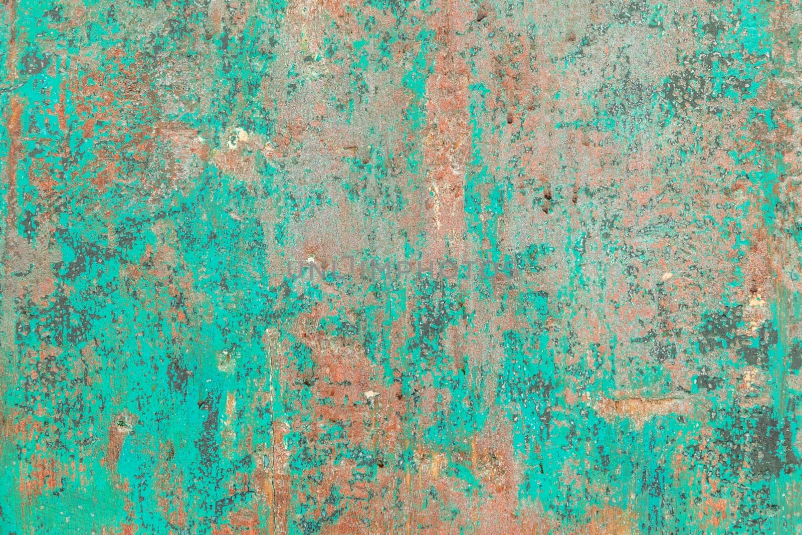 pattern of grunge wall with different colors covered by peeling green color in harmonic structure symbolizing age