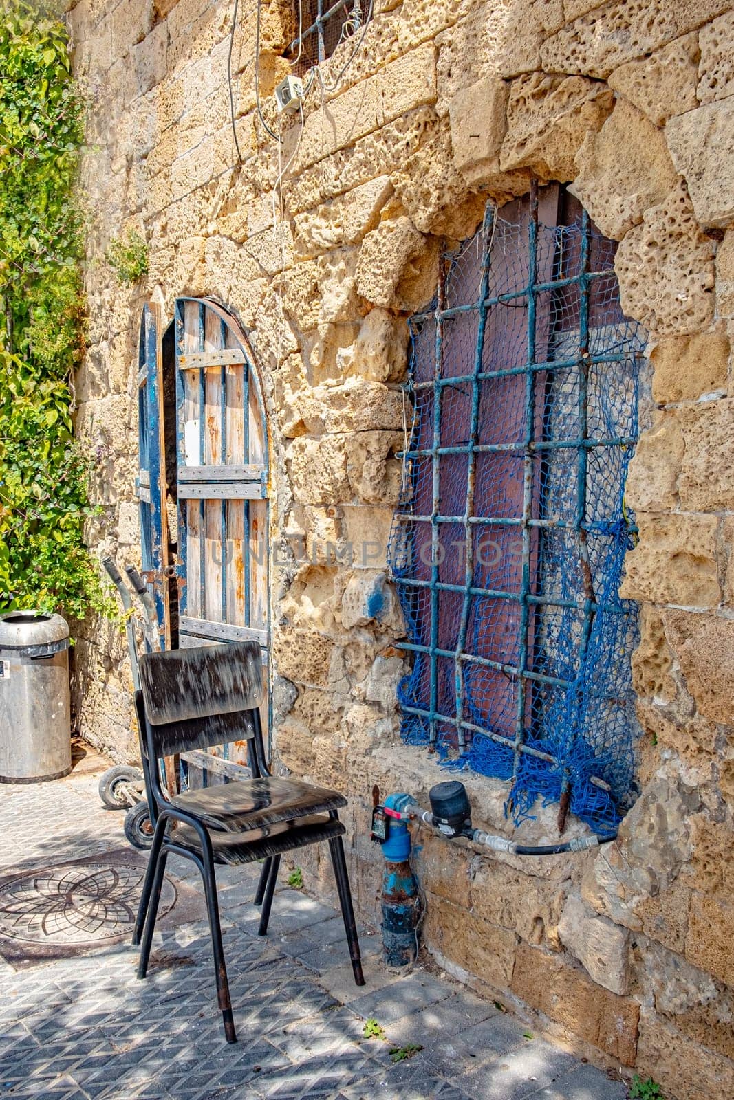 idyllic restaurant with painted chair in an old building in the old town of Tel Aviv, Israel