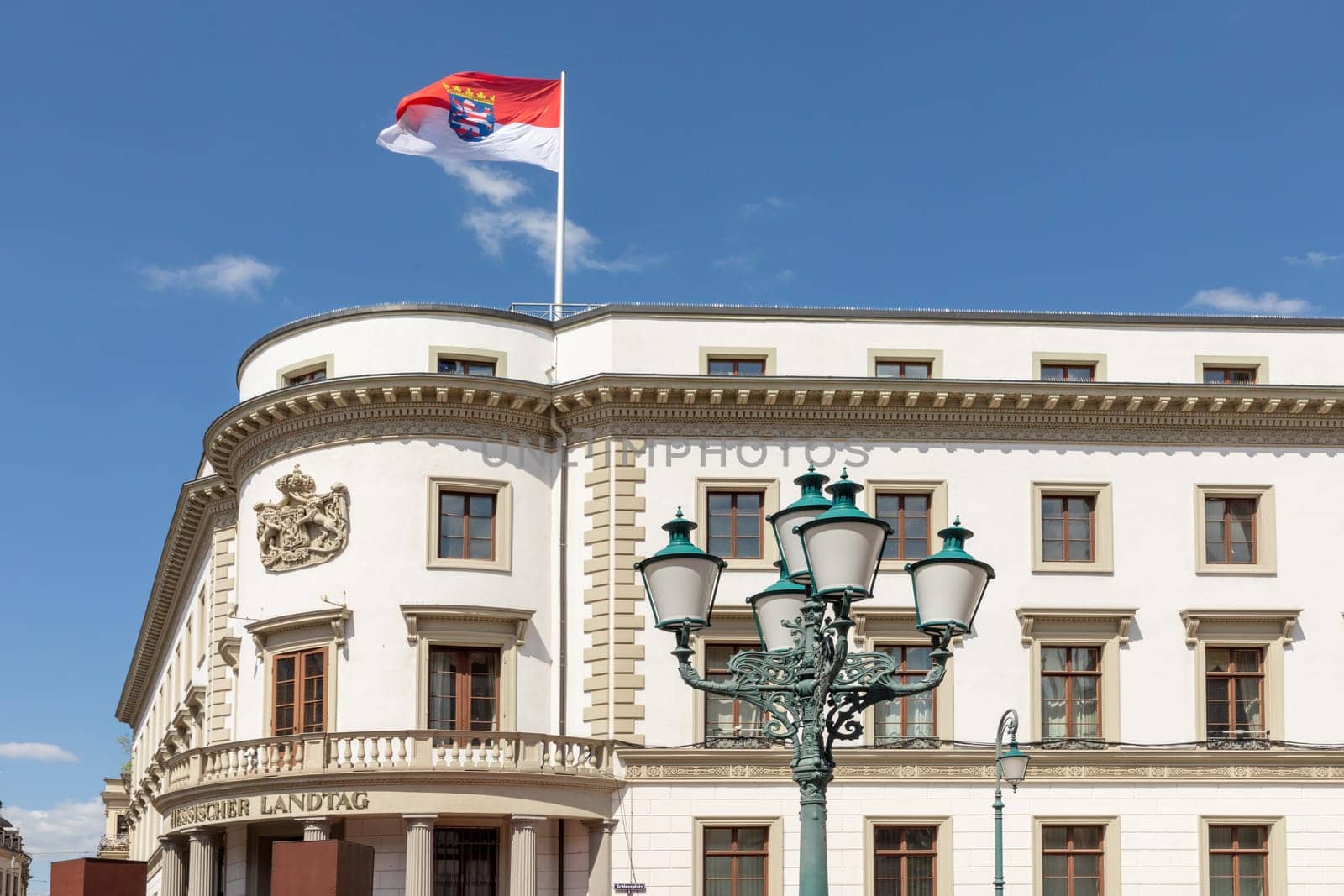 view to renovated facade of the Hesse parliament in Wiesbaden, Germany with fluttering flag