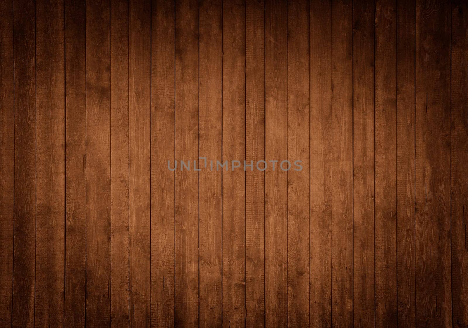 Wooden background made of vertical brown boards with darkening on the sides
