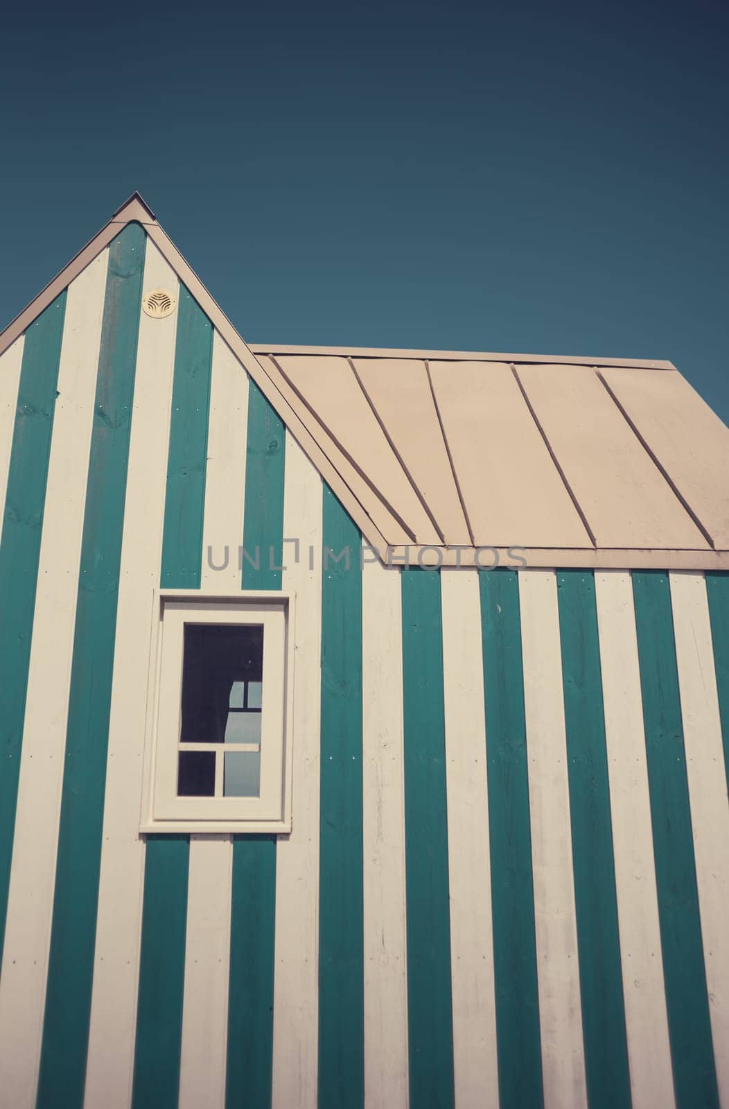 Little blue and white striped tiny house, close to the coast. Photography taken in France