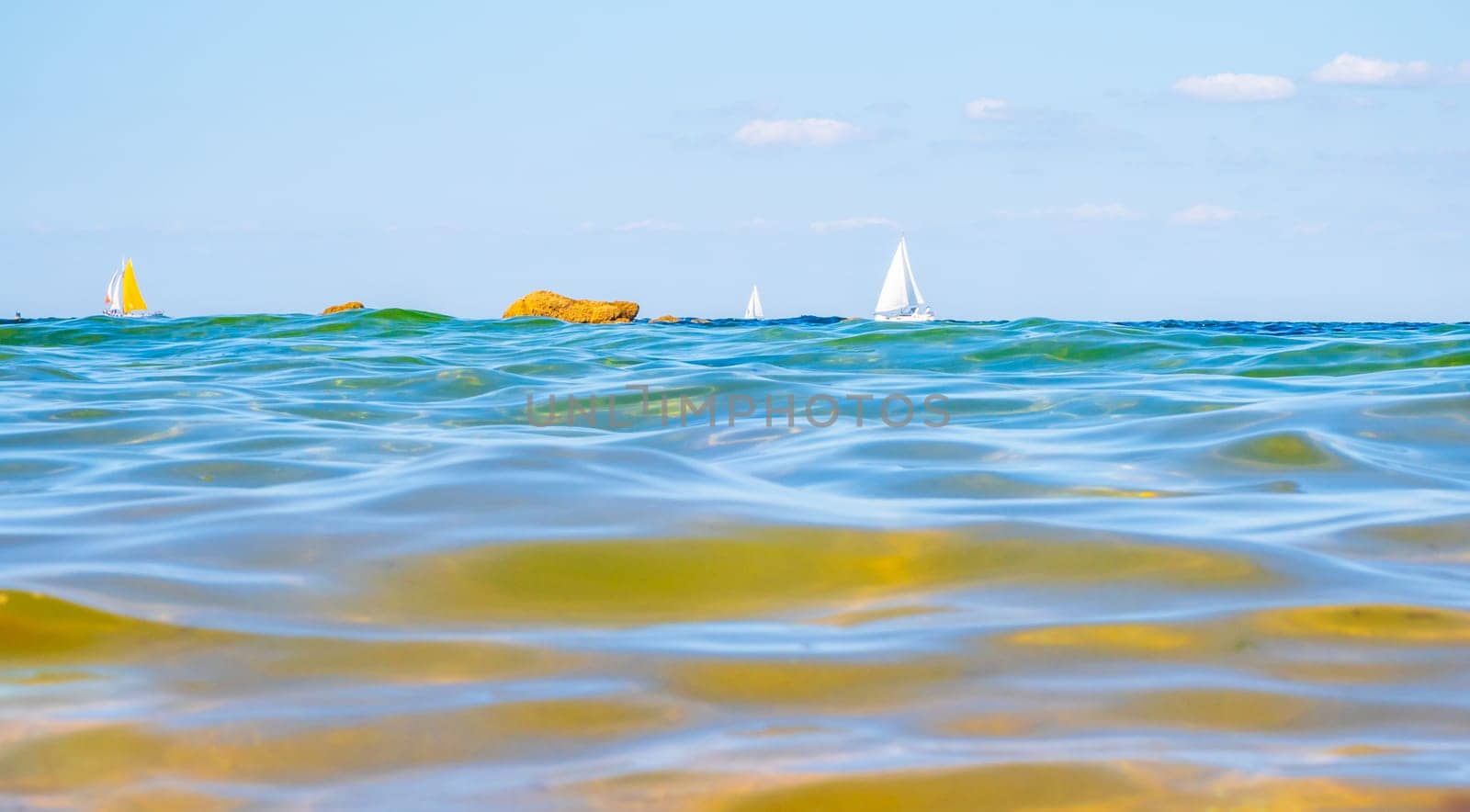 Sailing boats and waves seen by a swimmer at sea level, photography taken in Vendée, France