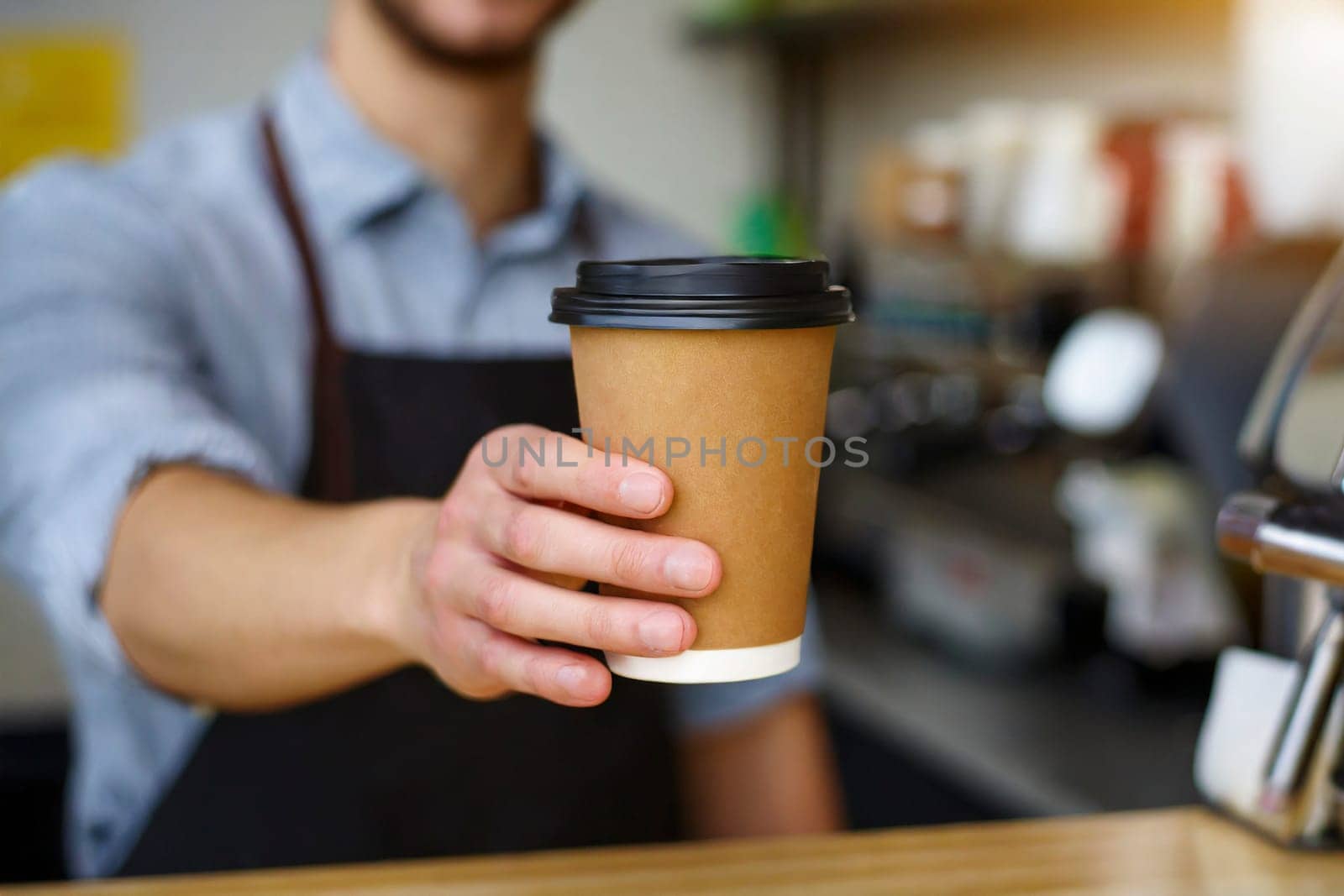 Coffee to go in hand of barista in coffee shop. AI generated