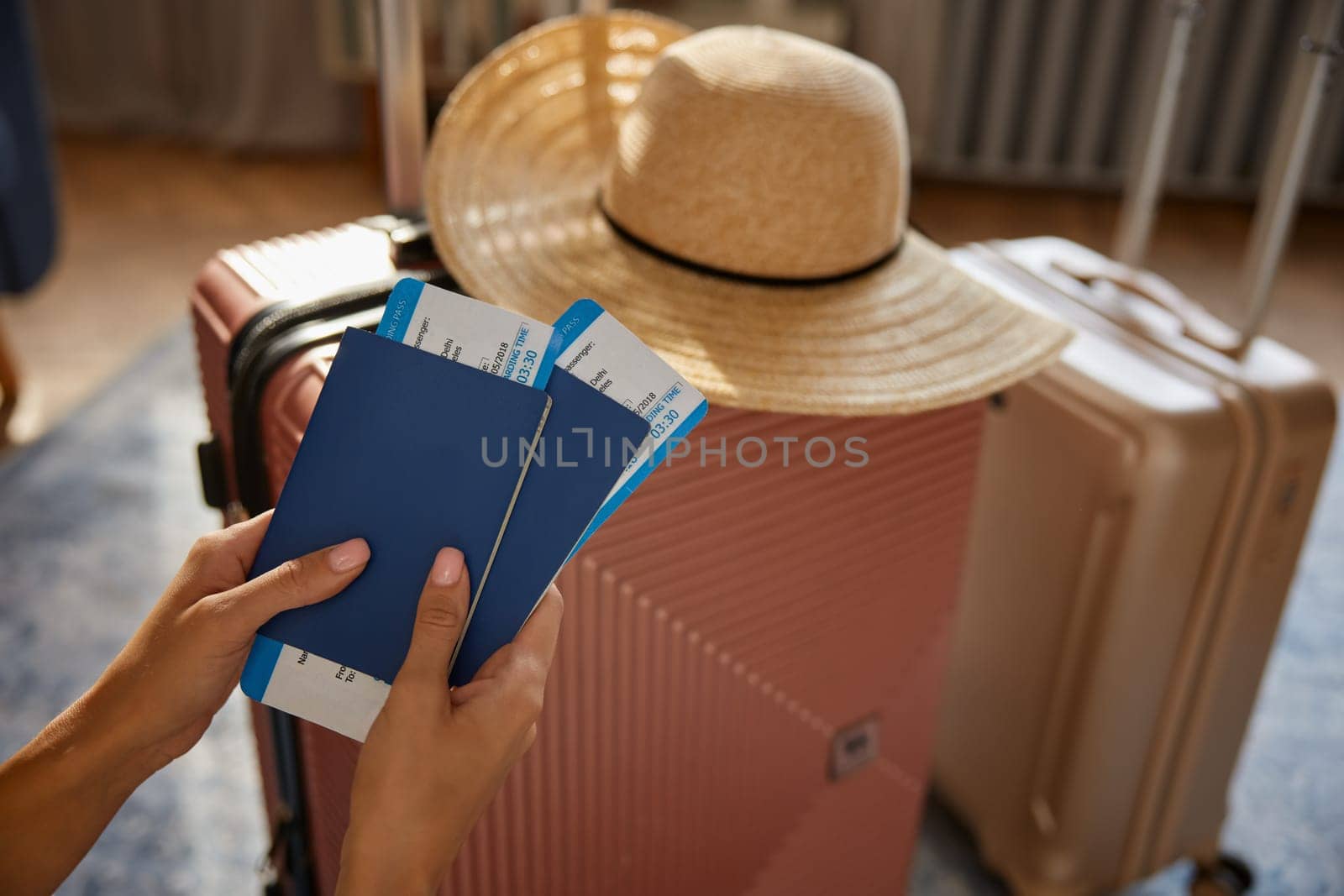 International travel, abroad journey and resort vacation start. Female holding passport and ticket with boarding pass over packed luggage bags