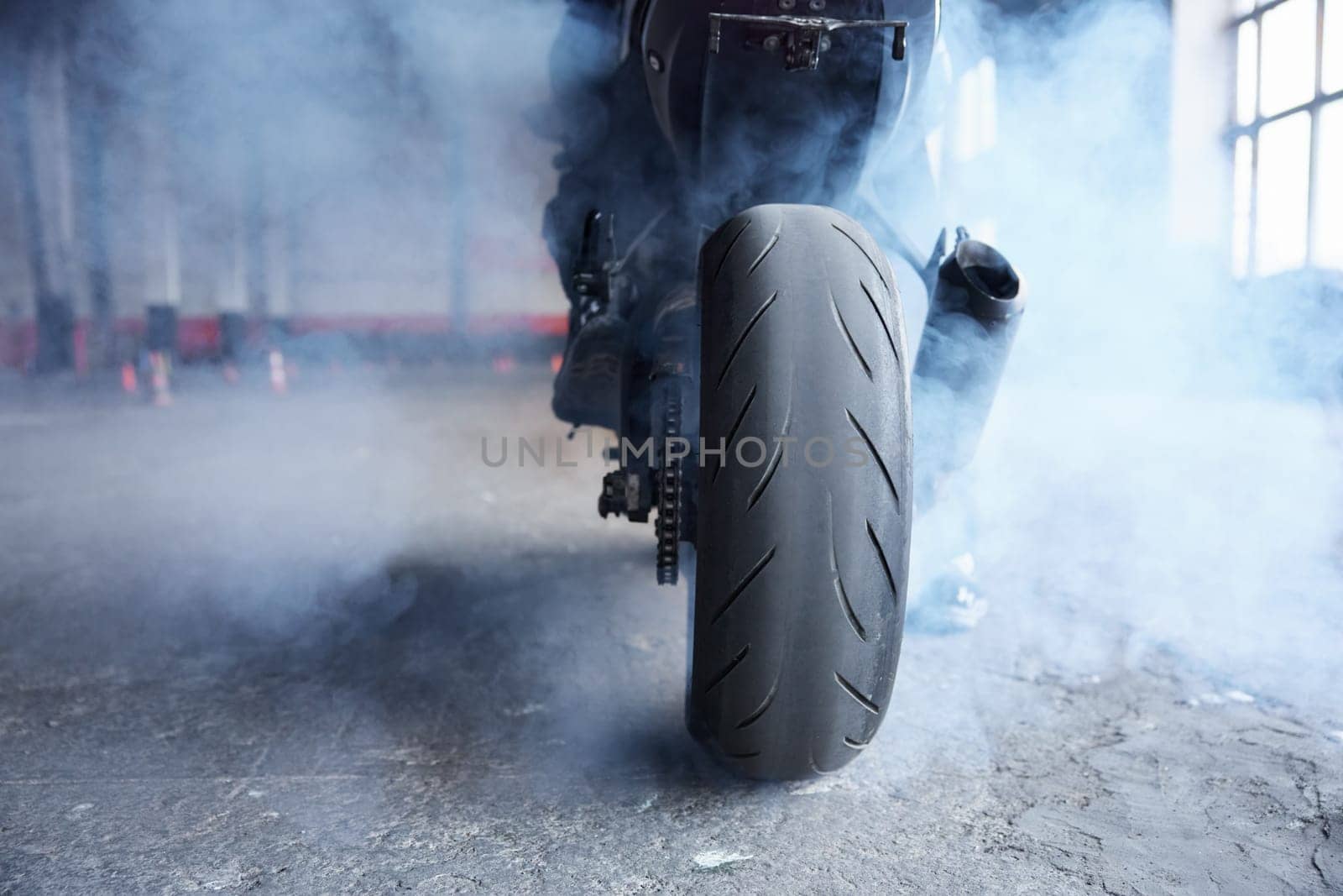 Motorcyclist squeezing clutch to start training race at motordrome. Driving school professional occupation
