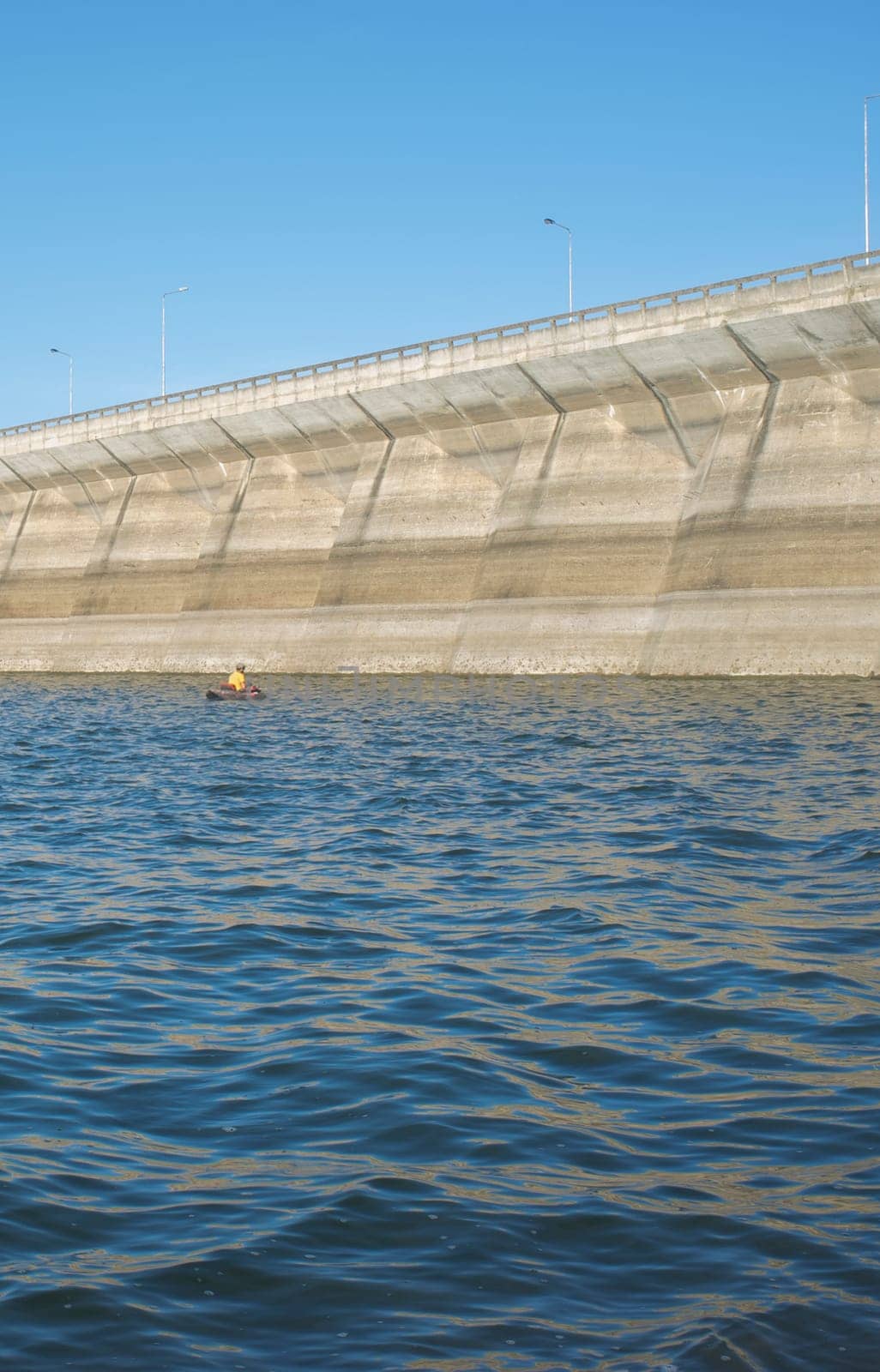 Float tube fisher close to Barragem do Caia wall, Campo Maior, Alentejo, Portugal
